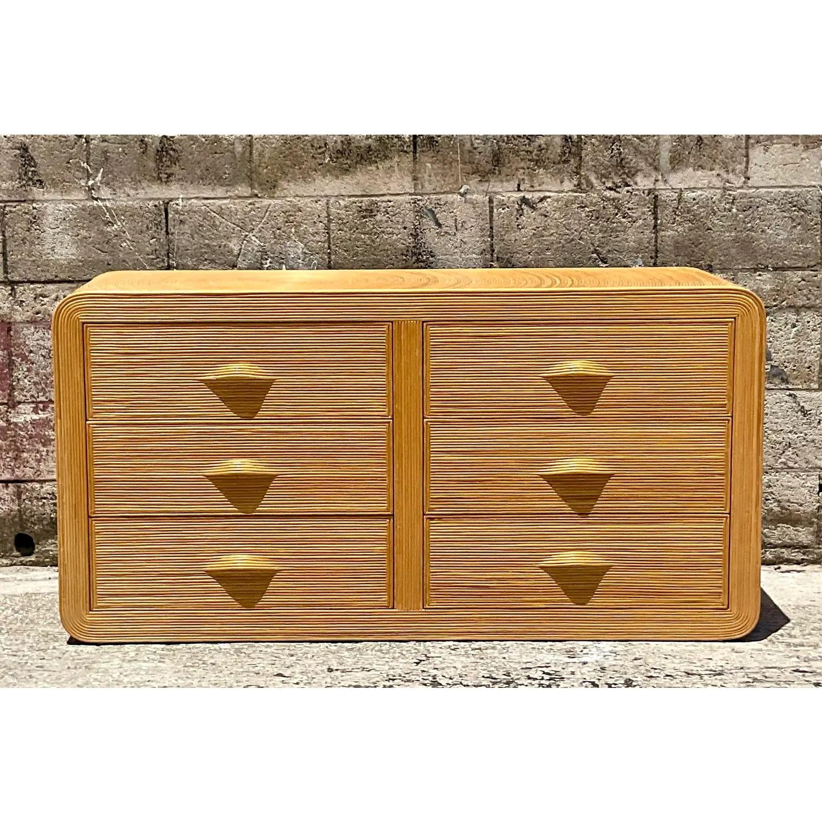 A fantastic vintage Coastal standard dresser. A stunning pencil reed cabinet in a chic starburst design. Beautiful waterfall edge. Acquired from a Palm Beach estate.