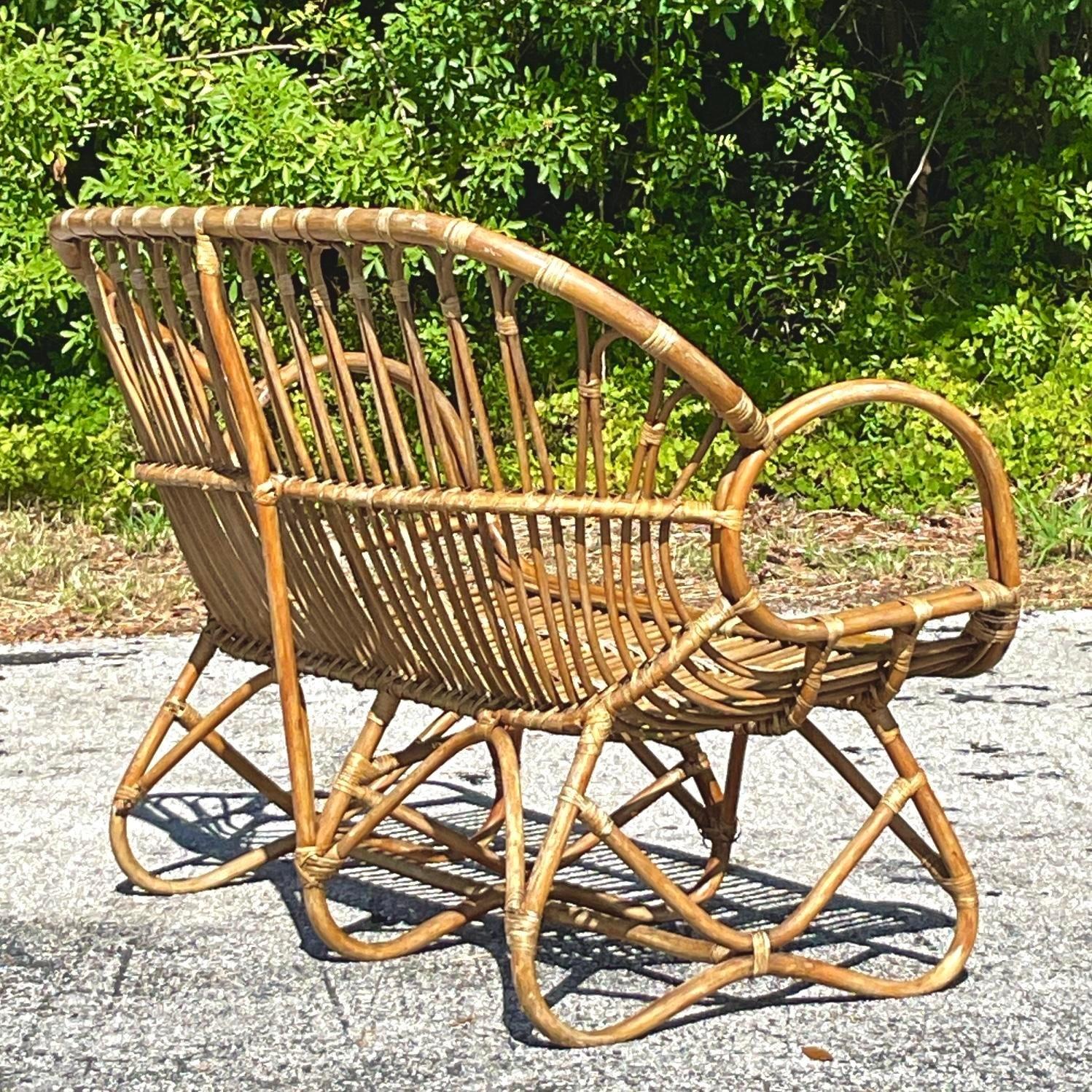 Bring seaside elegance to your space with this Vintage Coastal Stick Rattan Loop Loveseat. Its unique looped design and durable rattan frame offer a blend of style and comfort, making it perfect for sunrooms, patios, or living areas. Embrace the