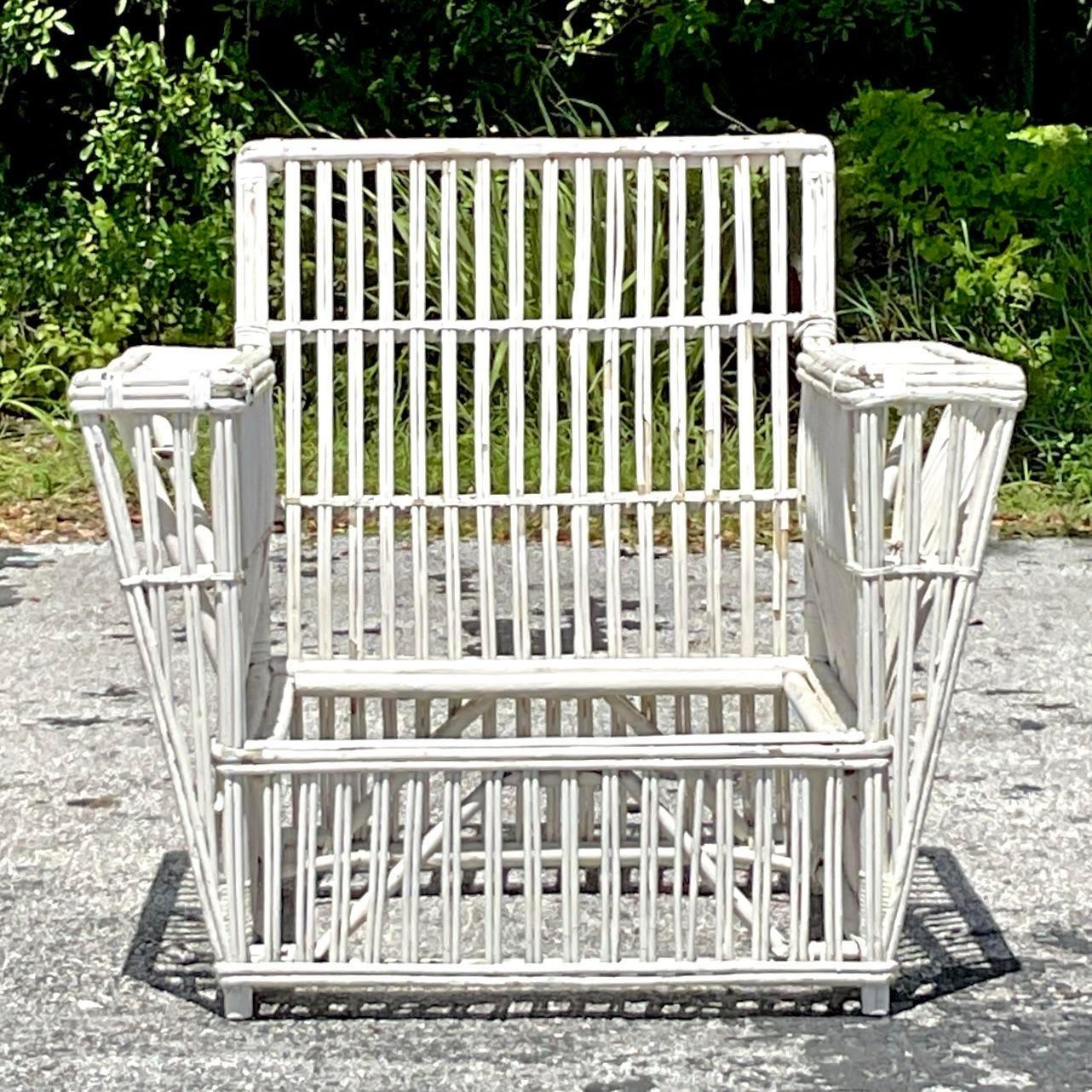 Experience timeless elegance with this Vintage Coastal Stick Rattan Lounge Chair, inspired by the iconic designs of Bielecky Brothers. Perfect for any seaside retreat or sophisticated home, it blends classic craftsmanship with coastal charm.