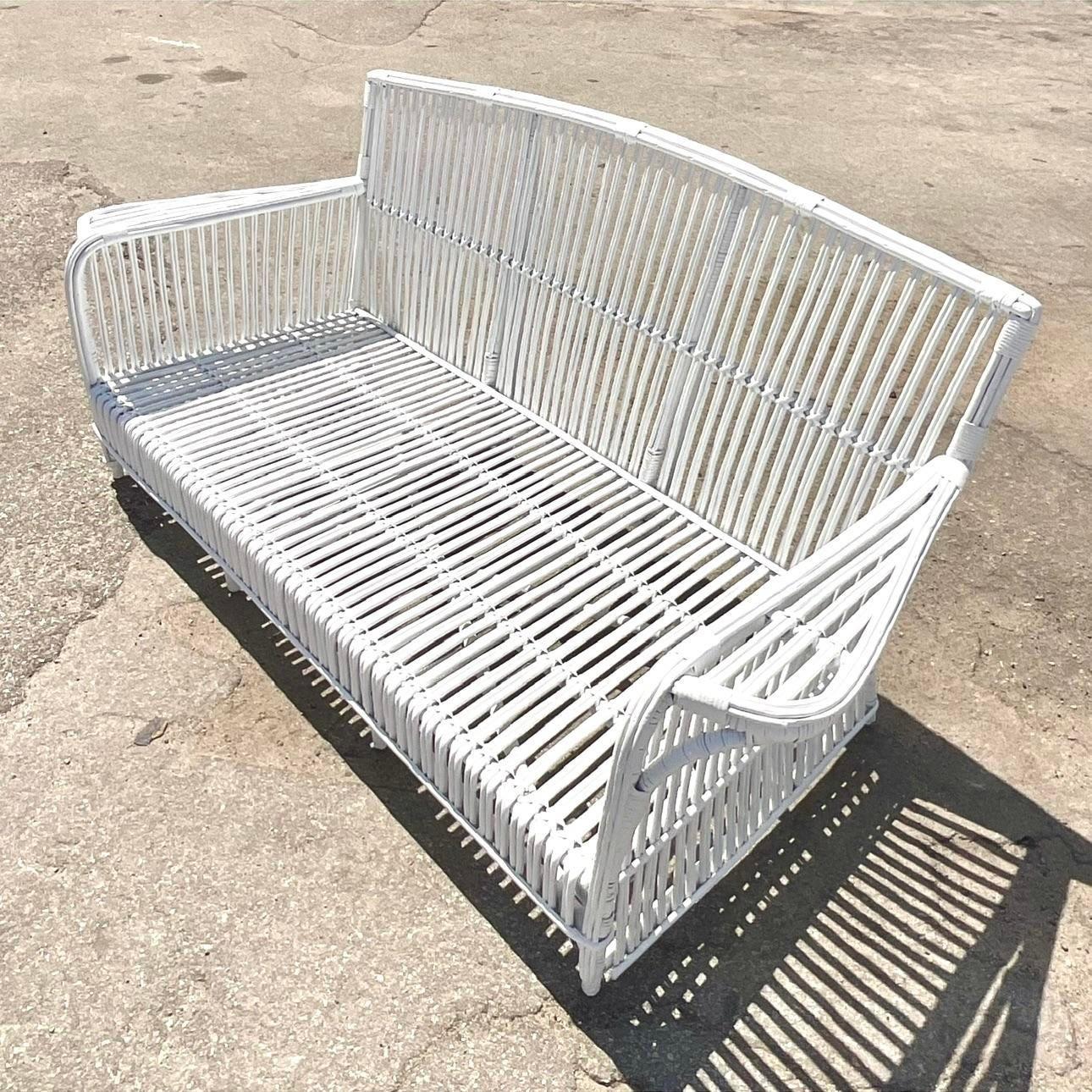 A fantastic vintage Coastal Stick rattan sofa. Done in the manner of the iconic Bielecky Brothers. Bright white color in a semi gloss finish. Acquired from a Palm Beach estate.