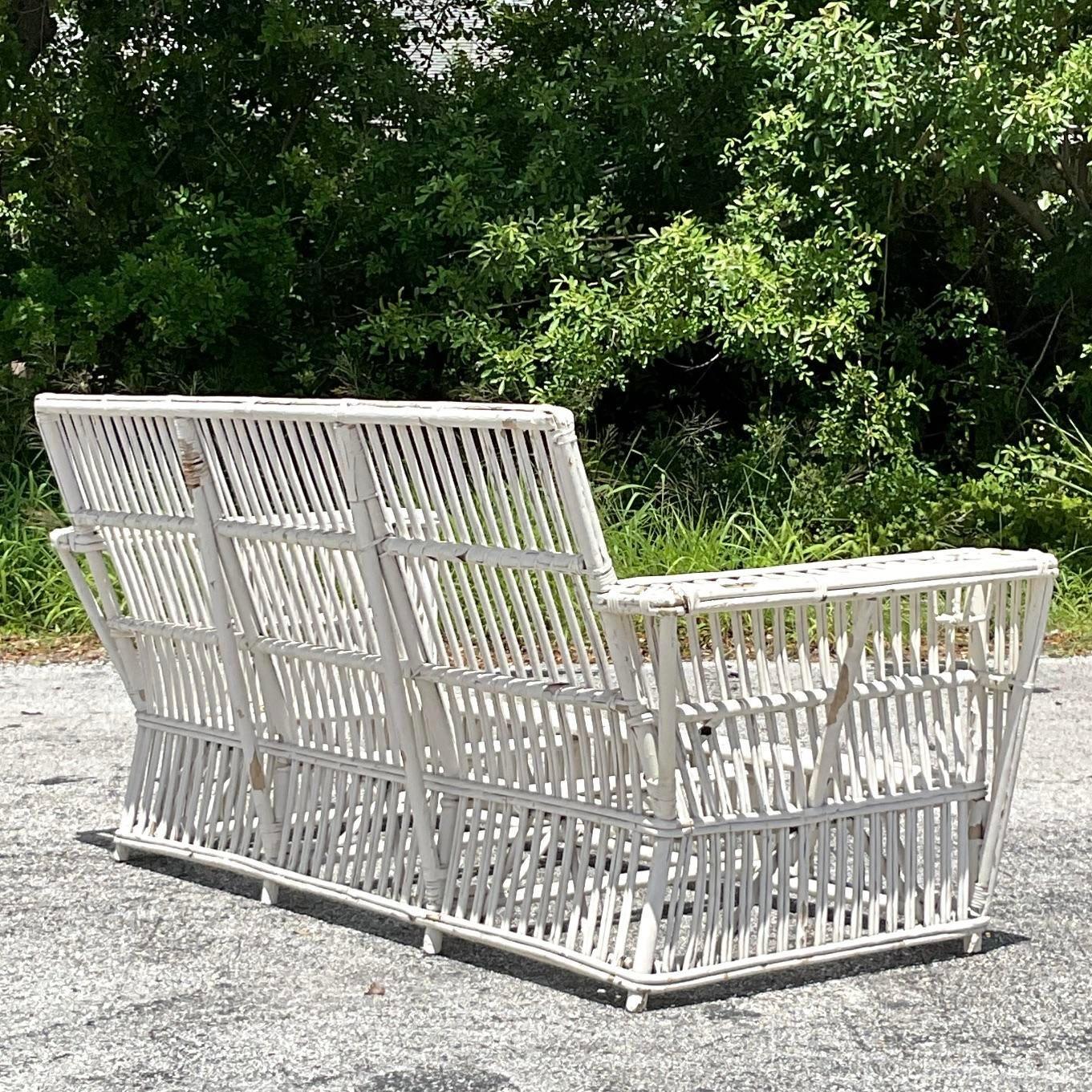 Elevate your decor with the Vintage Coastal Stick Rattan Sofa, inspired by the Bielecky Brothers. This exquisite piece combines coastal elegance with masterful rattan craftsmanship, offering both style and comfort for your living space.