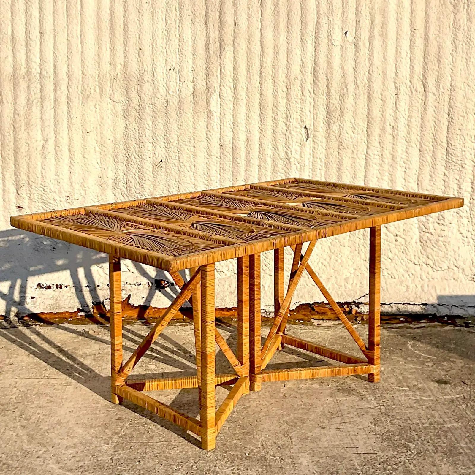 A fabulous vintage Coastal dining table. The beautiful iconic starburst design in a wrapped rattan frame. Super wrapped truss design pedestal. Acquired from a Palm Beach estate.