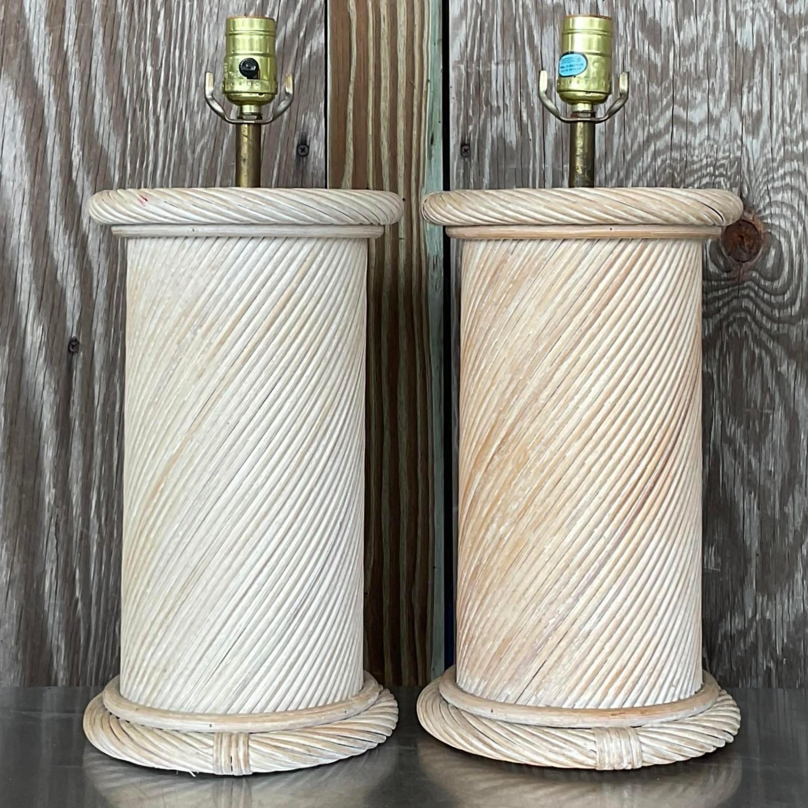 A fabulous pair of vintage Coastal table lamps. Chic swirl pencil reed construction in a washed finish. Acquired from a Palm Beach estate.