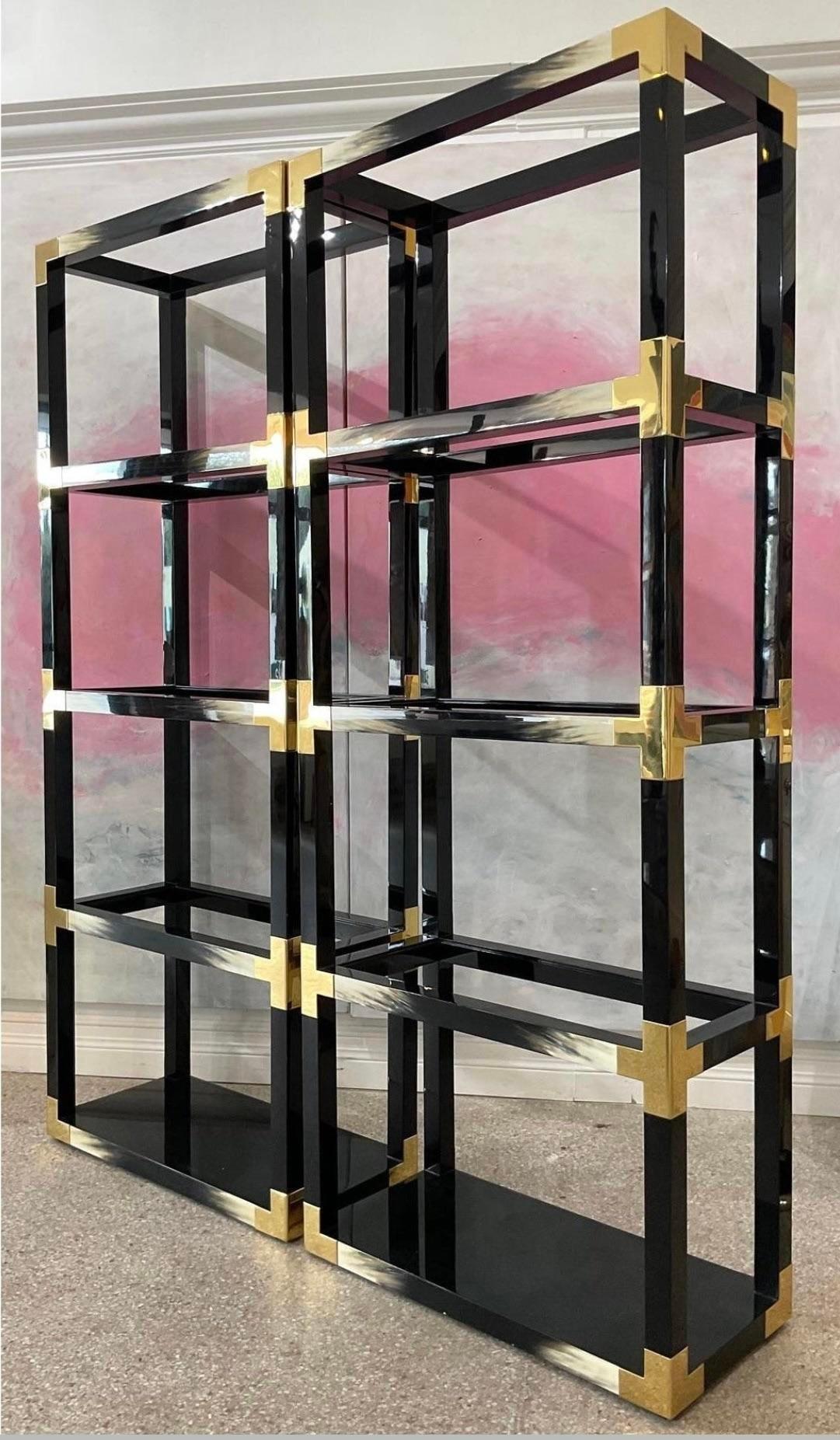 A fabulous pair of vintage Boho etagere. Made by the iconic Theodore Alexander and tagged on the bottom. Gorgeous deep brown faux horn with polished brass joints. Inset glass shelves add to the glamour. Acquired from a Palm Beach estate.