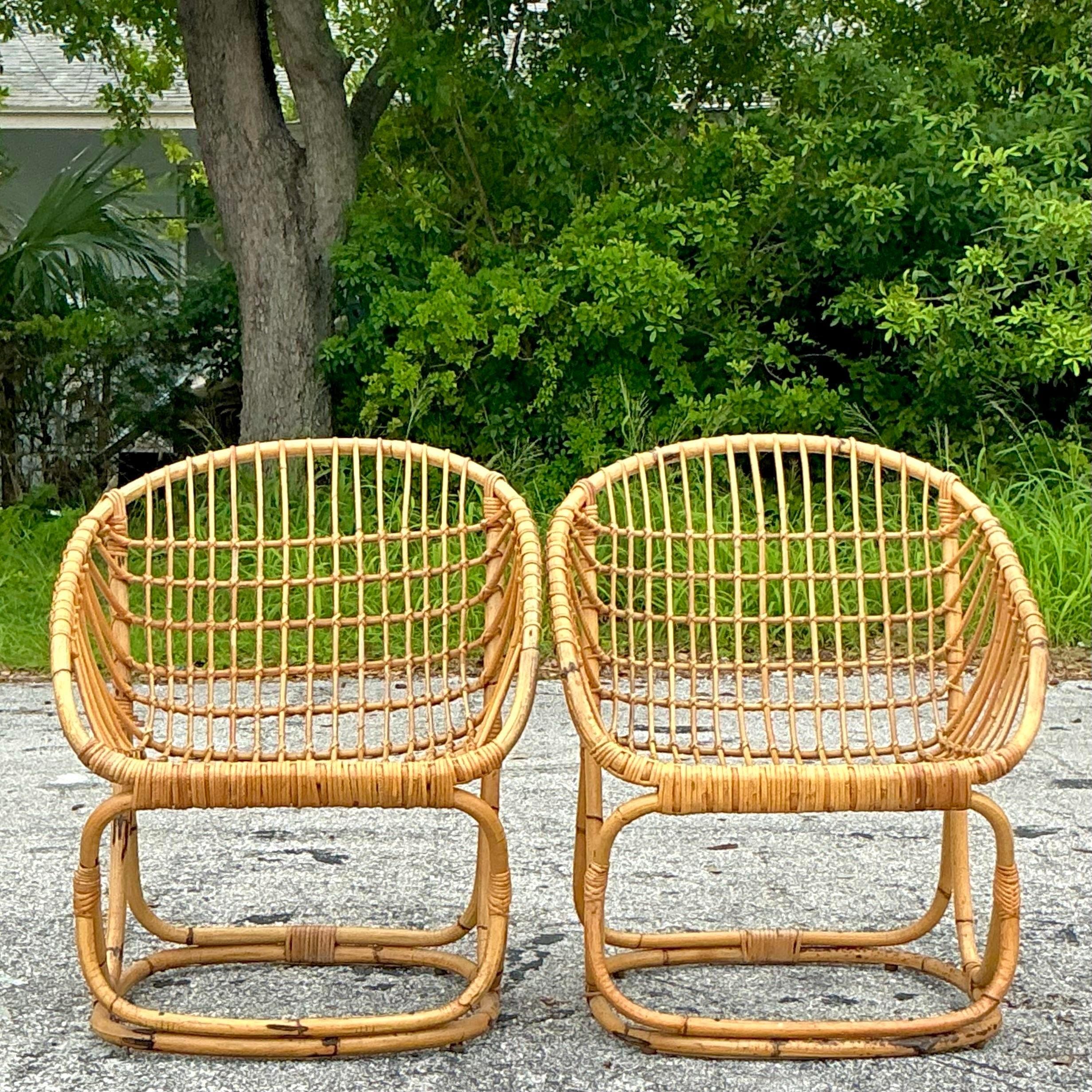 Transform your living space with the timeless charm of Vintage Coastal Tito Agnoli Woven Rattan Lounge Chairs. These exquisite pieces blend coastal elegance with mid-century design, featuring masterfully woven rattan for a natural, breezy aesthetic.