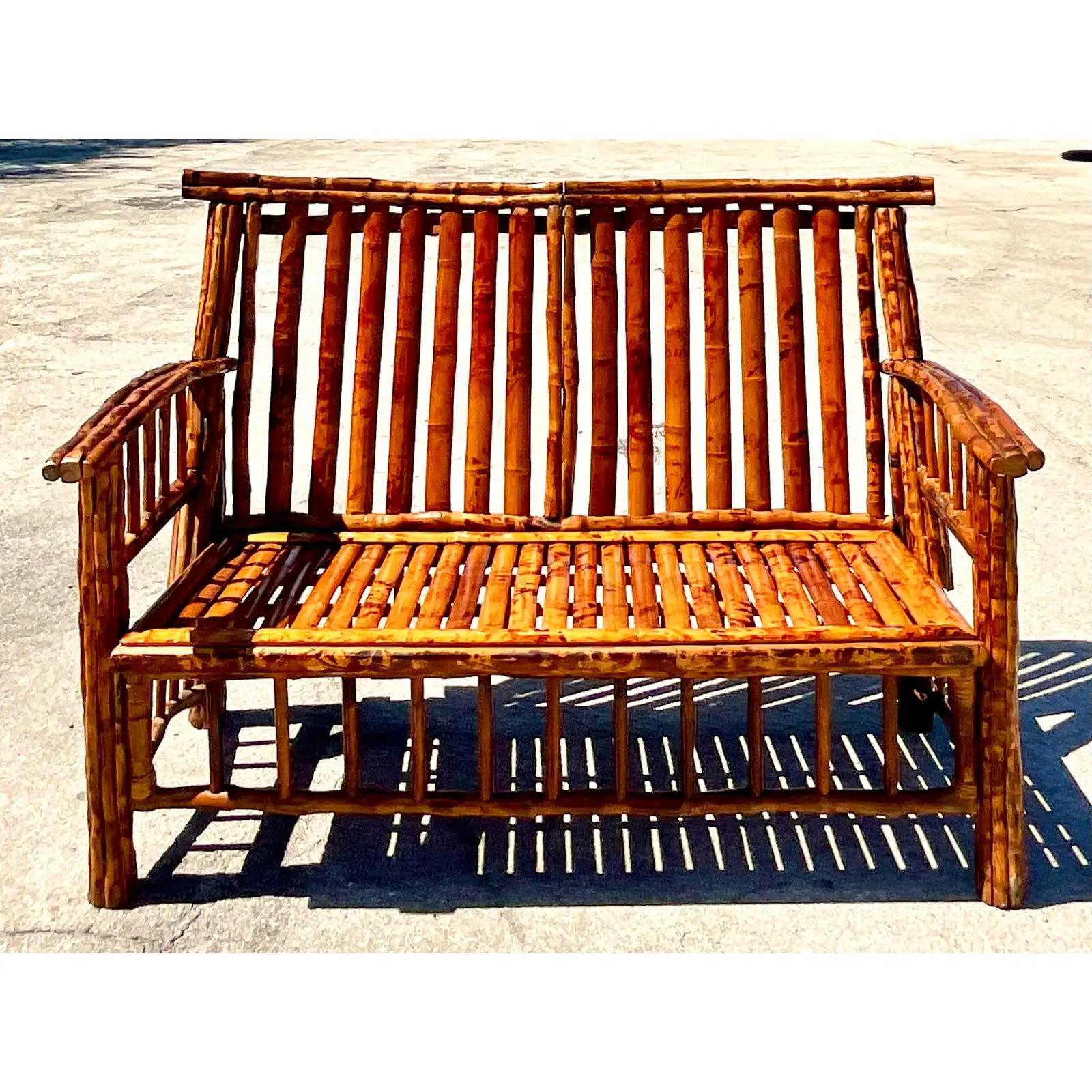 Fantastic vintage Coastal Tortoise shell bamboo bench. Beautiful deep rich browns and tans on a classic rustic design. Great to add a little glamour to any space. Acquired from a Palm Beach estate.