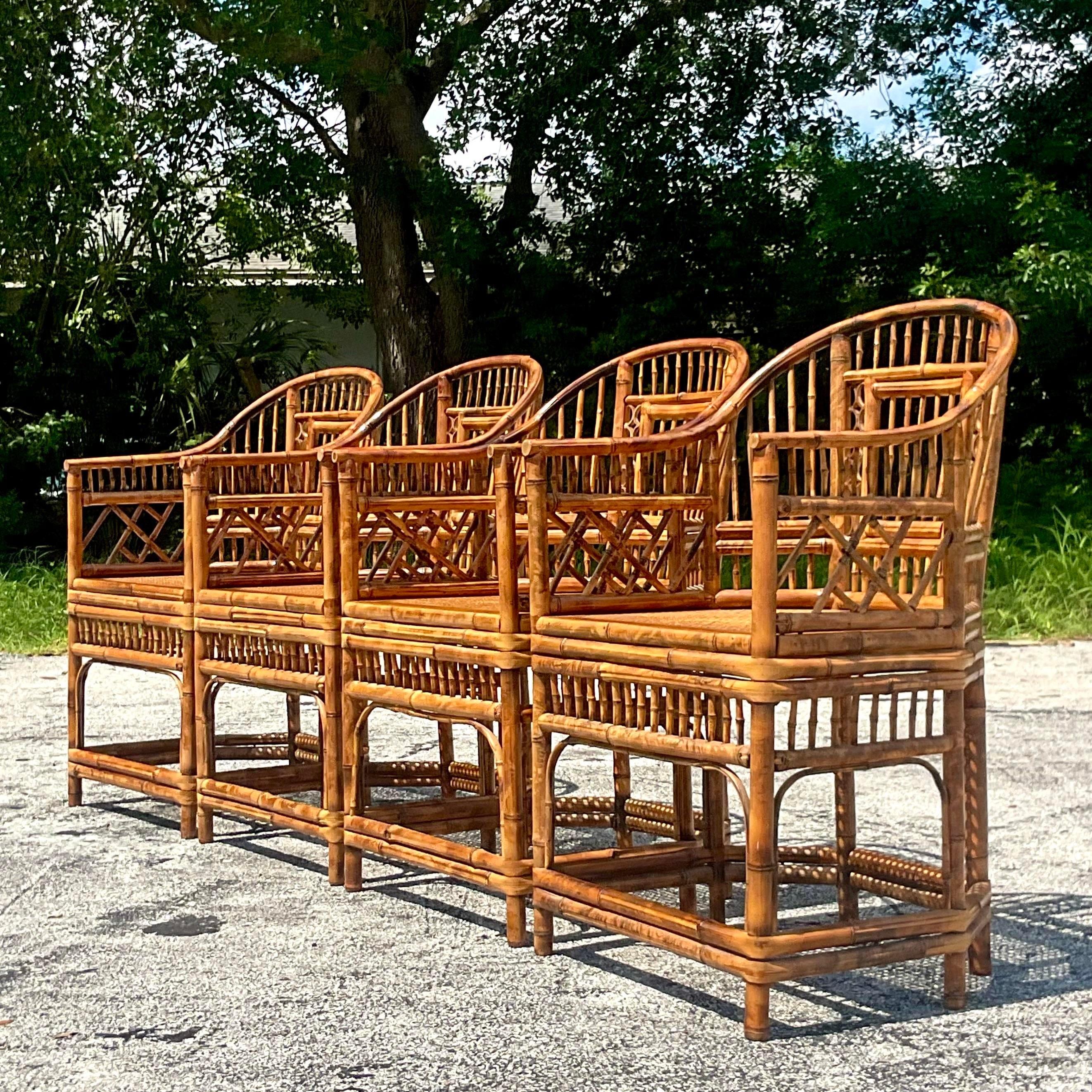 A fabulous set of four vintage Coastal dining chairs. The coveted Brighton Pavilion chair in tortoise shell bamboo. Inset cane seats. Acquired from a Palm Beach estate.