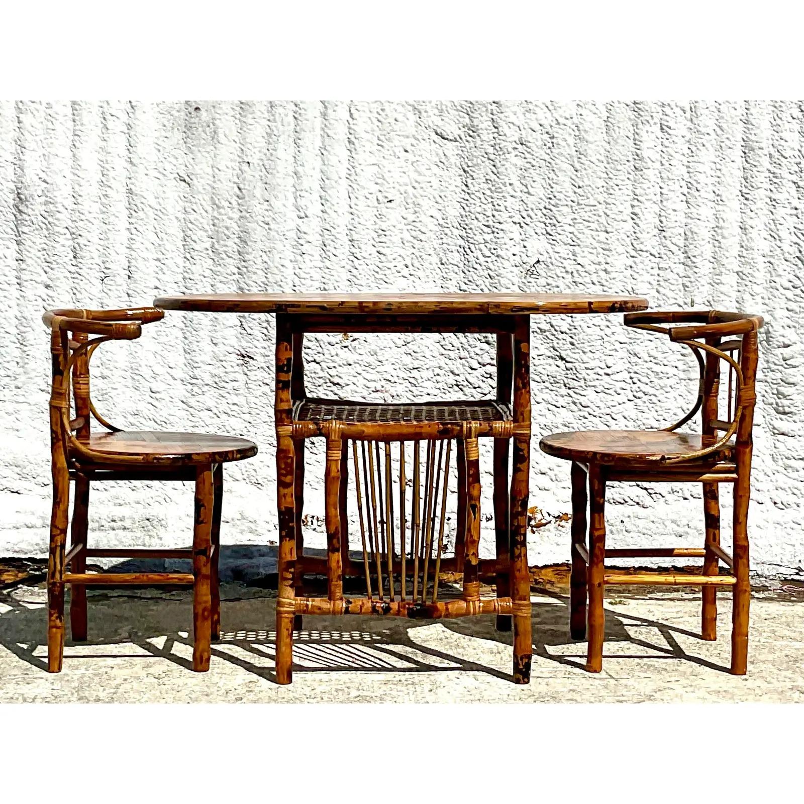 Fabulous vintage Coastal Honeymoon set. Beautiful tortoise shell rattan in a high gloss finish. Two little seats with an oval table. Acquired from a Palm Beach estate.