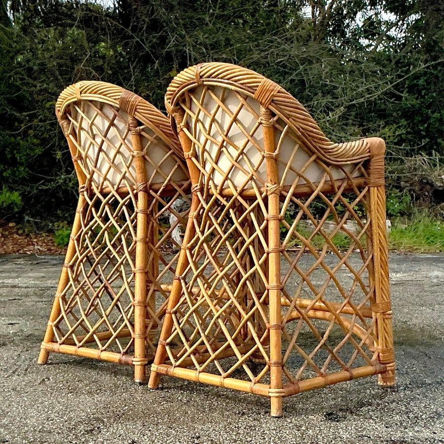 Enhance your bar or kitchen with this beautiful pair of Vintage Coastal Trellis Rattan Bar Stools. Featuring intricately woven rattan frames with a charming trellis design, these stools bring a light and breezy coastal feel to any space. The