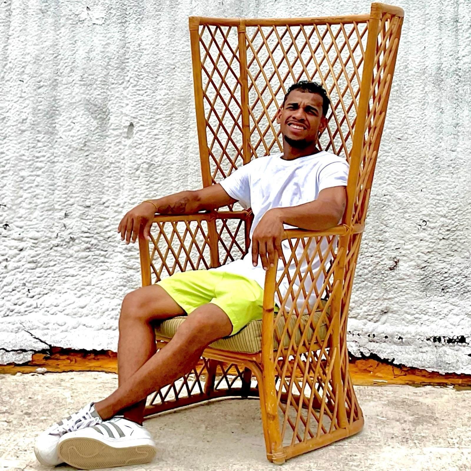 Experience timeless elegance with our Vintage Coastal Trellis Rattan Wingback Chair. This American-style masterpiece features intricately woven rattan and a classic wingback design, perfect for adding a touch of coastal charm and sophistication to