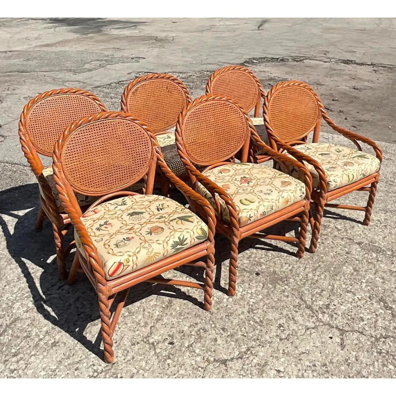 A fabulous set of 6 Coastal dining chairs. A fabulous twisted design with a cane back and a chic painted percale cushion. Made by the iconic McGuire groups. Tagged on the bottom. Acquired from a Palm Beach estate.