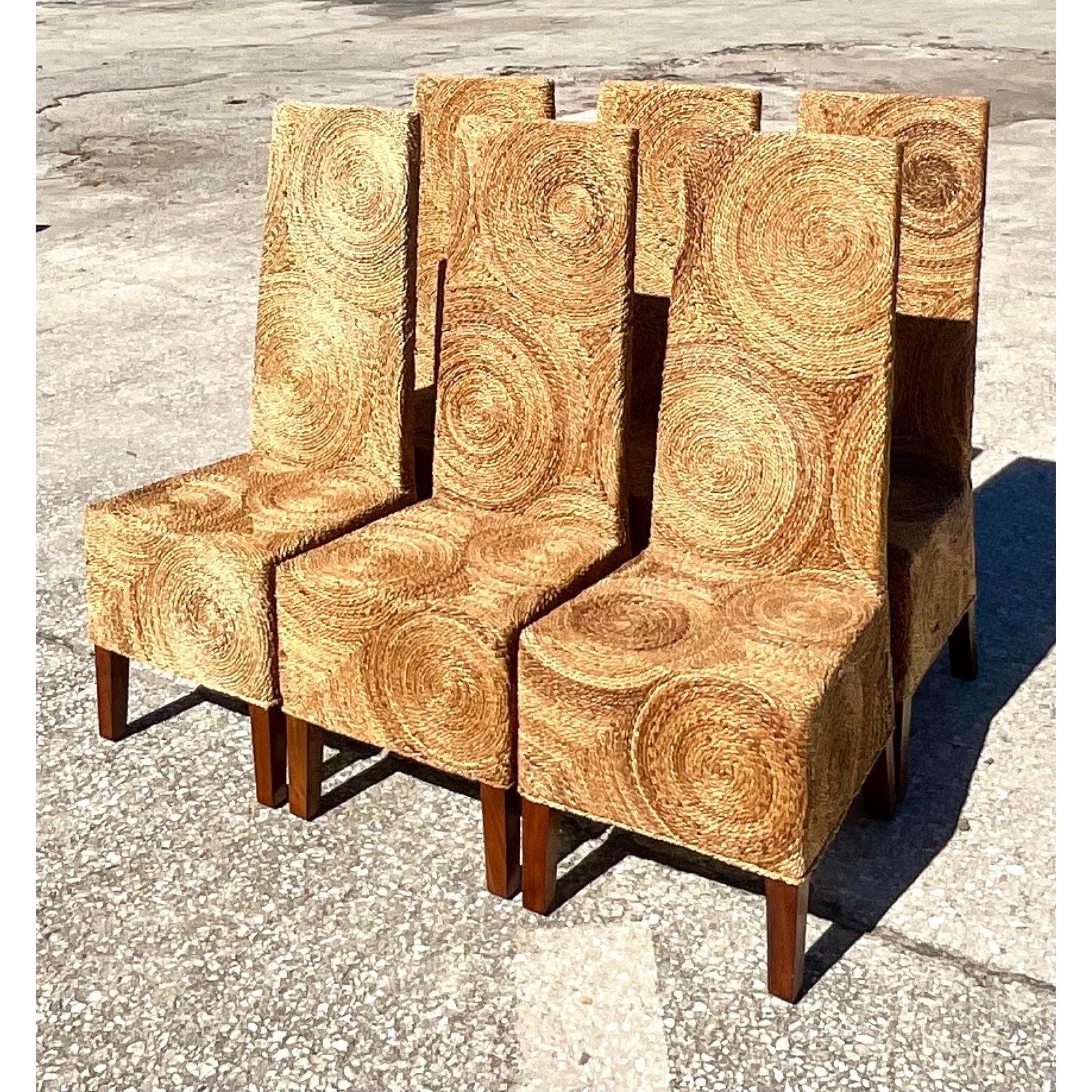 Fantastic vintage coastal dining chairs. Beautiful twisted rattan in a circles design. High backs and wood legs make these an easy addition to any décor. Acquired from a Palm Beach estate.
