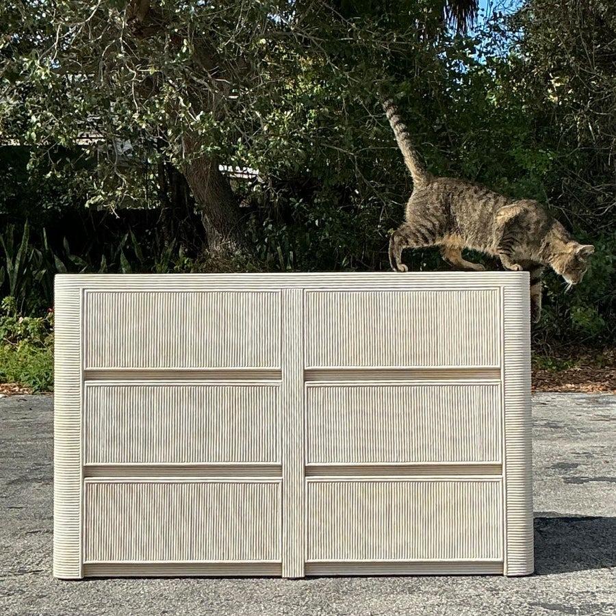 This vintage coastal pencil reed dresser is a stunning blend of timeless design and practical function. The washed finish highlights its natural textures, creating a light and airy aesthetic perfect for coastal or modern interiors. With its six