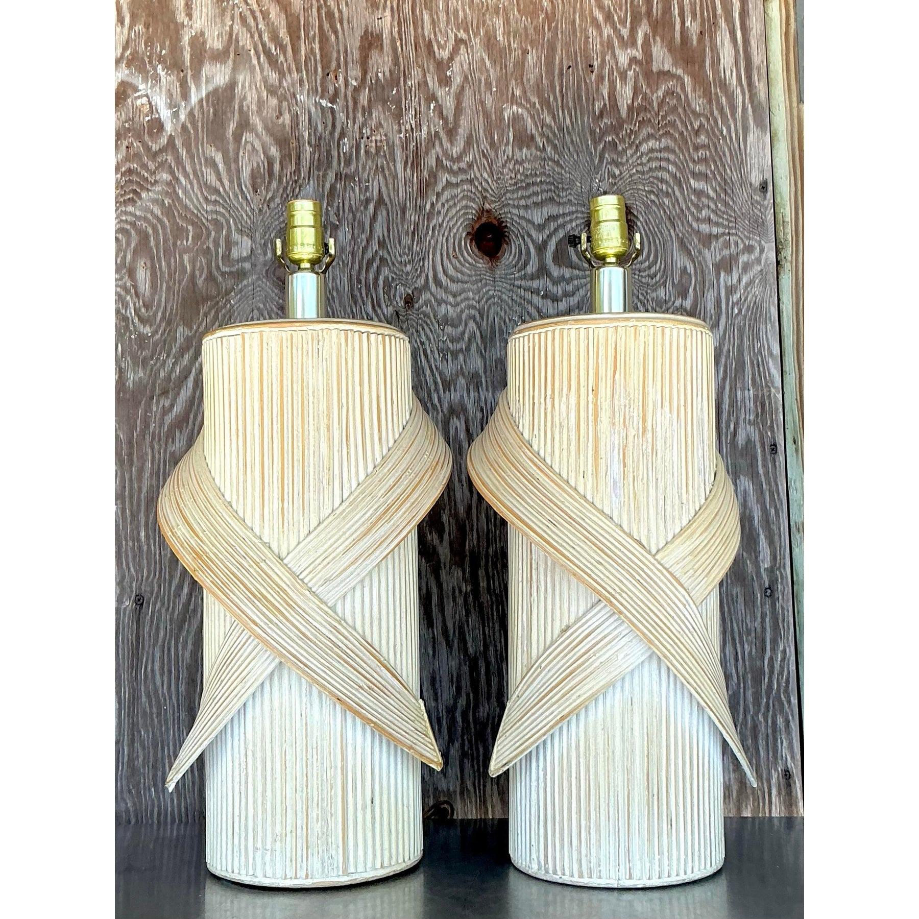 Elevate your interior with this stunning pair of vintage coastal-inspired pencil reed lamps. Featuring a beautifully washed finish, these lamps embody natural elegance with their hand-wrapped design and textured details. Perfect for adding a touch