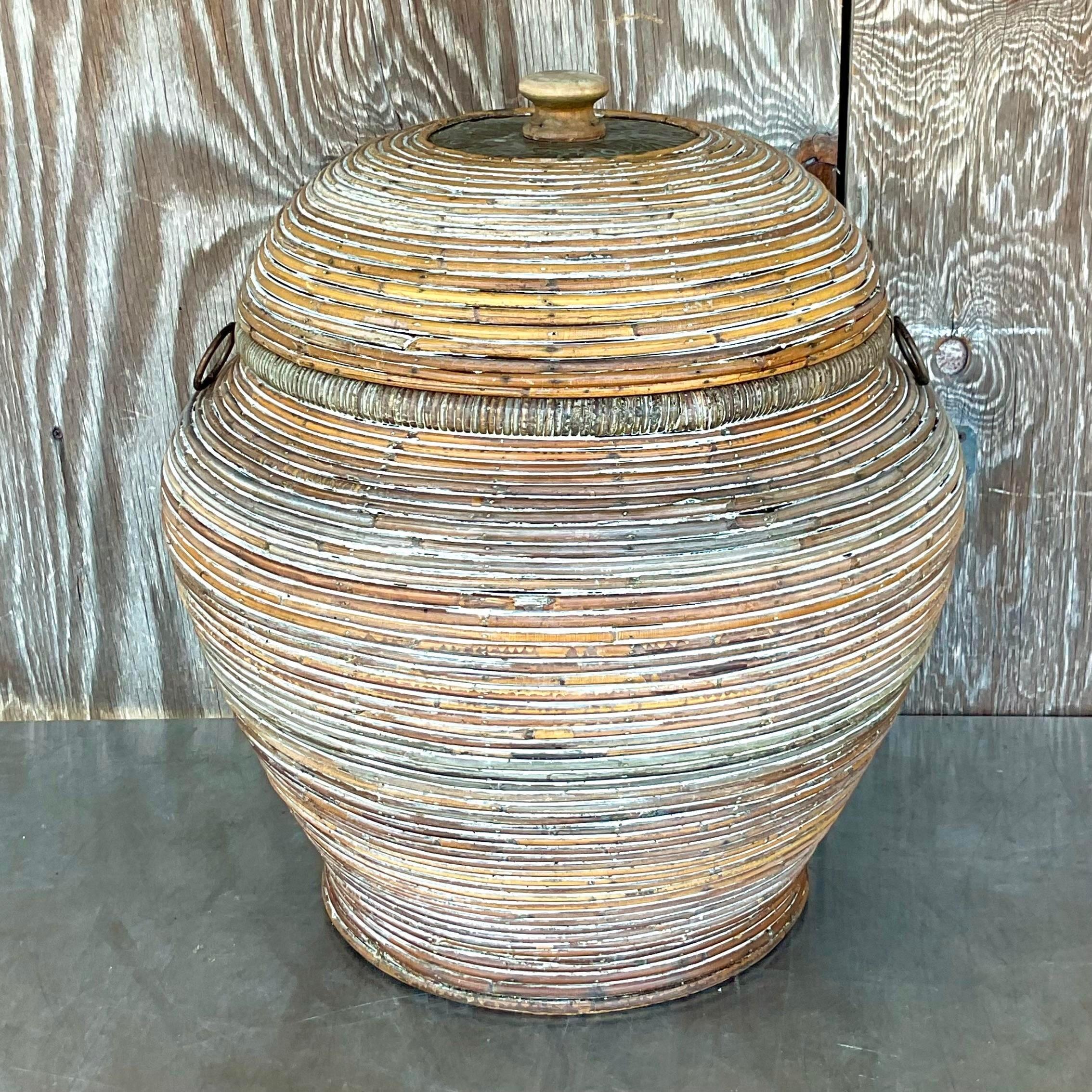 Organize with coastal charm using our Vintage Coastal Washed Pencil Reed Lidded Basket, a fusion of American craftsmanship and seaside elegance. Handcrafted with meticulous attention to detail, this basket features a washed finish that evokes the