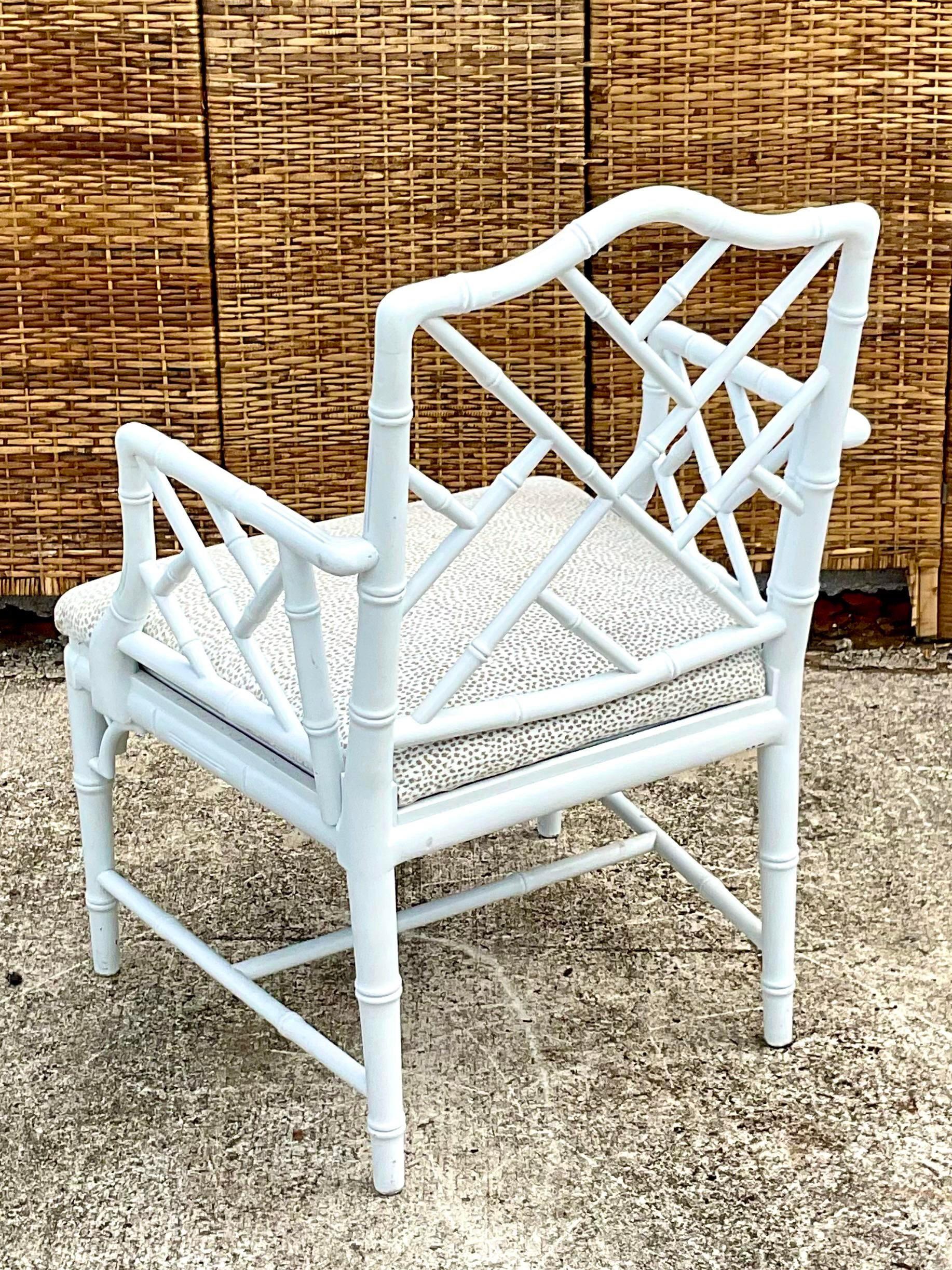 Fabulous pair of vintage Coastal arm chairs. Beautiful high gloss white lacquered finish. The iconic Chinese Chippendale design on the frame. A beautiful neutral dots upholstery make these an easy addition to any decor. Acquired from a Palm Beach