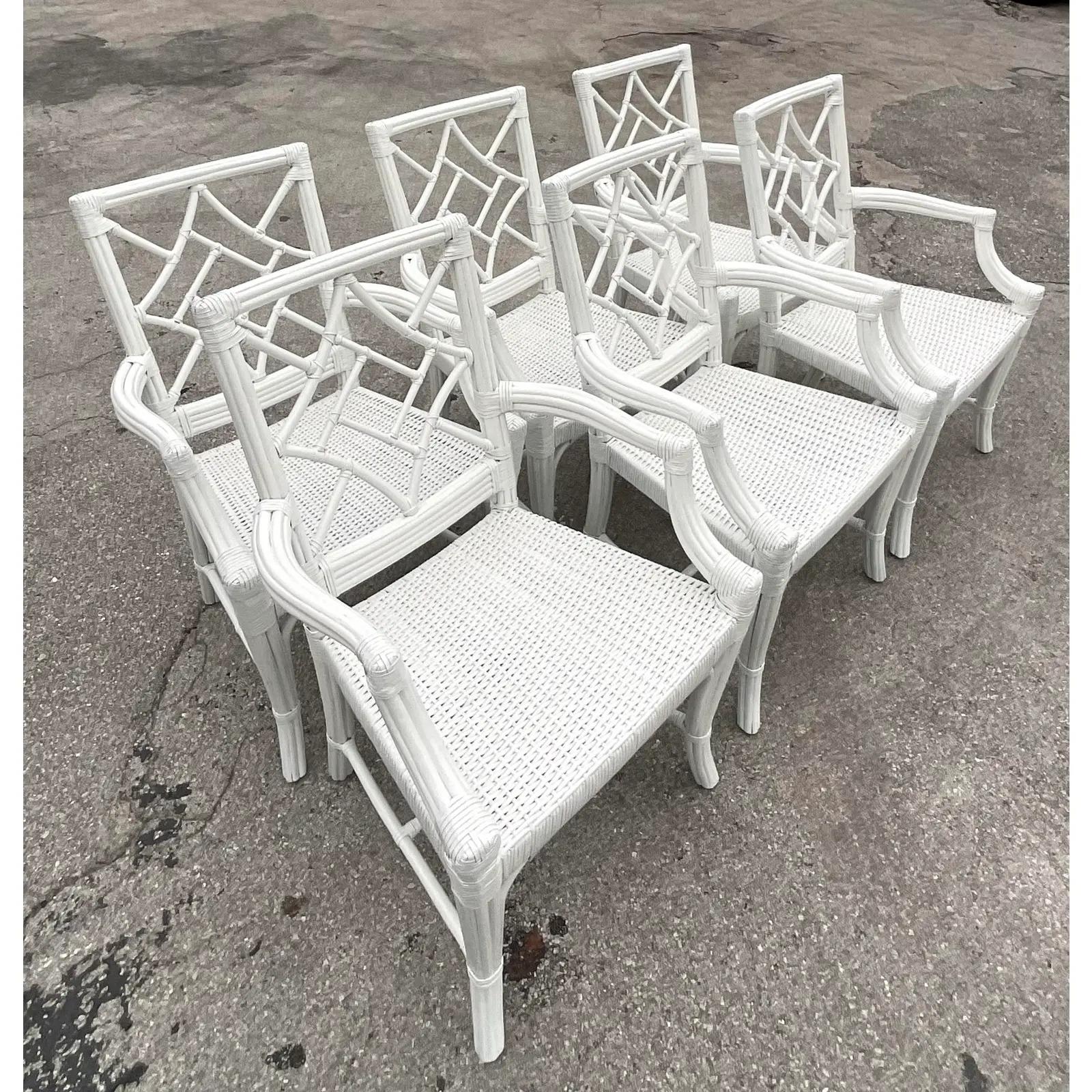 A beautiful set of six white lacquered dining chairs. Beautiful woven rattan with a rattan frame. Chic diamond back design. Acquired from a Palm Beach estate. 