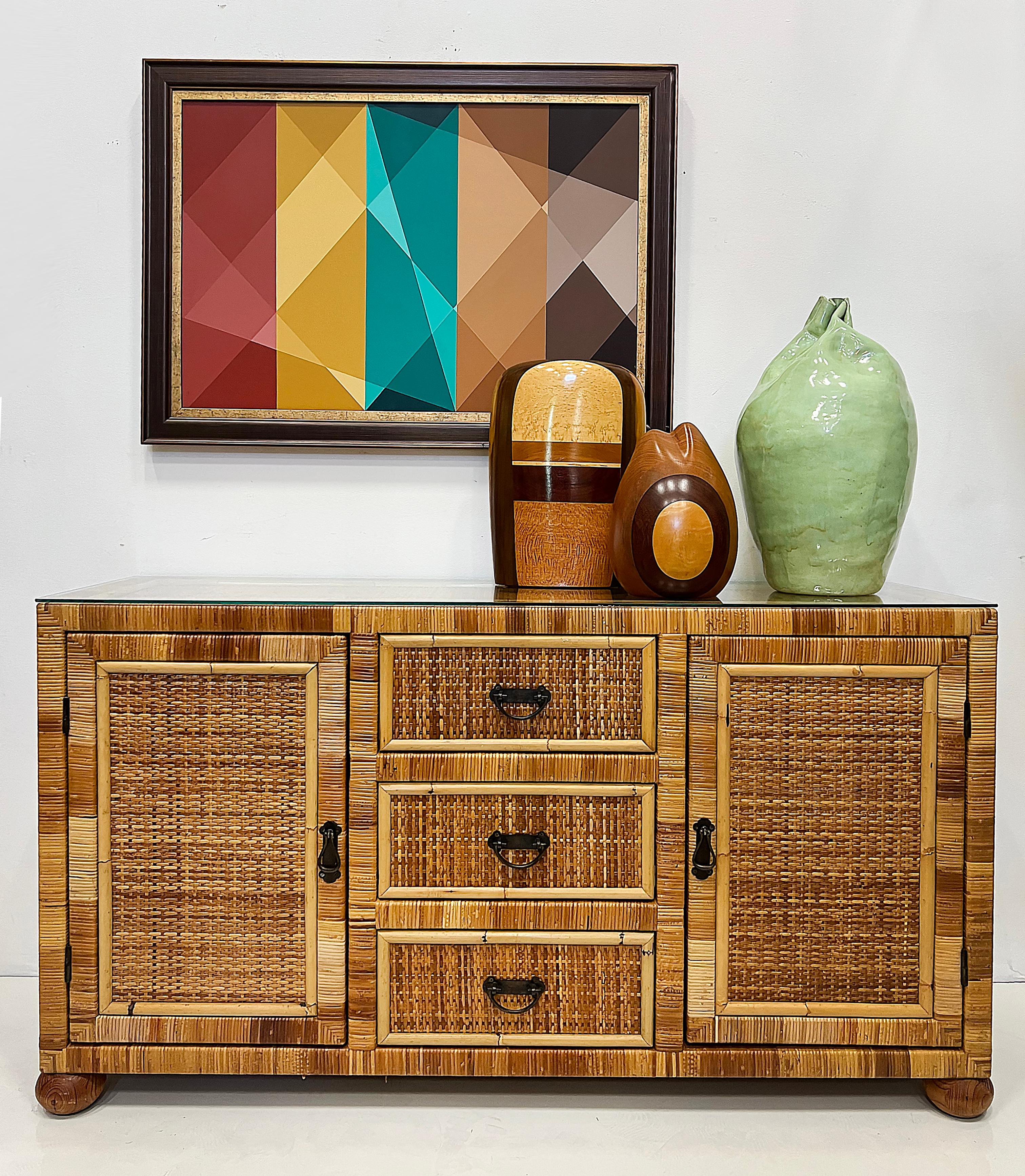 Vintage Coastal Woven Rattan and Wood Credenza 

Offered for sale  is a vintage Coastal woven rattan and wood credenza with a fitted glass top.  The frame is wrapped with split rattan and the top, as well as the drawers, are inset with woven cane. 