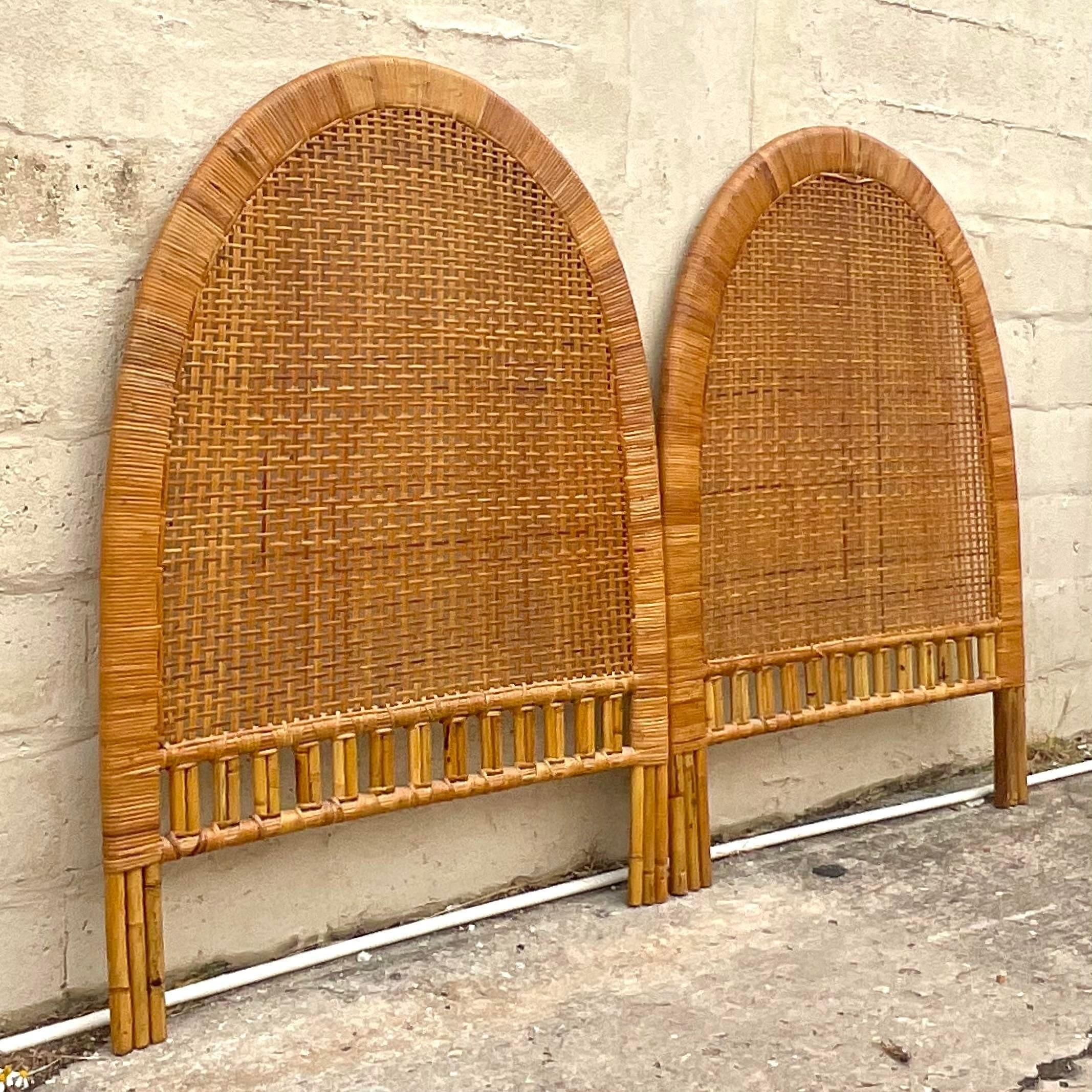 A fantastic pair of vintage coastal twin headboards. Beautiful woven rattan in a chic arched design. Acquired from a Palm Beach estate.