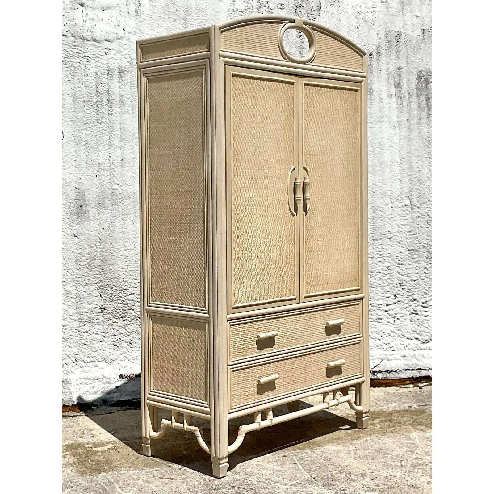 Fantastic vintage Coastal armoire. Tall and impressive with classic rattan trim and inset woven rattan panels acquired from a Palm Beach estate.