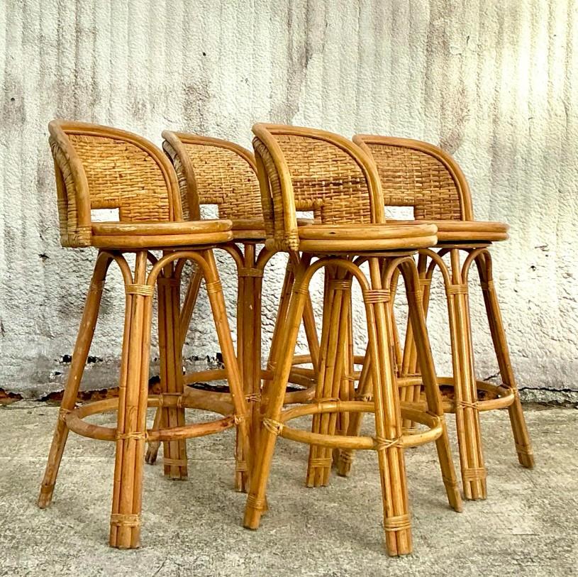This set of 5 vintage coastal bar stools captures the breezy charm of seaside style with their beautifully woven rattan design. These stools offer a natural warmth and texture that bring depth to any space, perfect for a relaxed, coastal-inspired