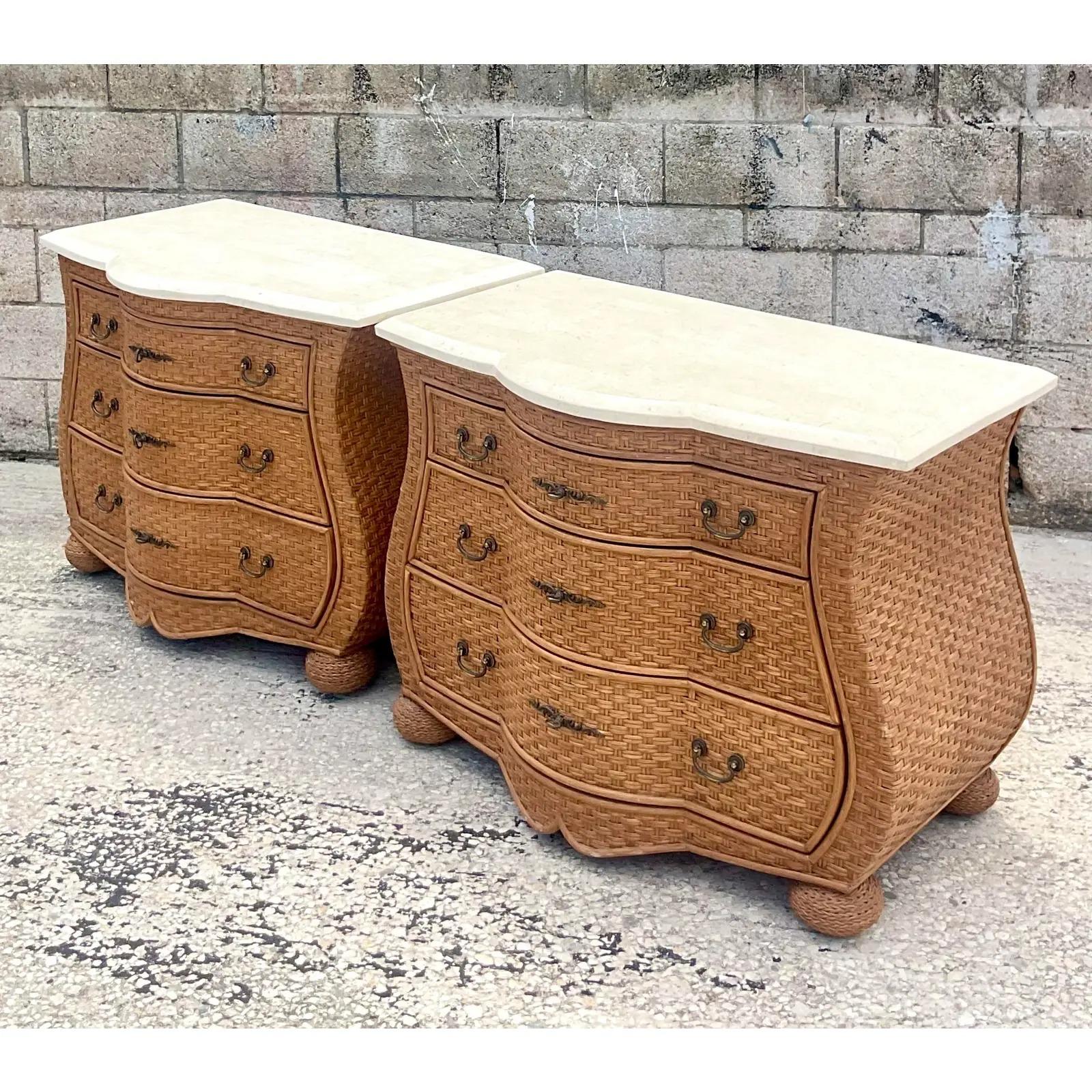Fantastic pair of vintage Coastal chests of drawers. Beautiful woven rattan in a chic Bombe shape. Tessellated stone tops. Acquired from a Palm Beach estate.