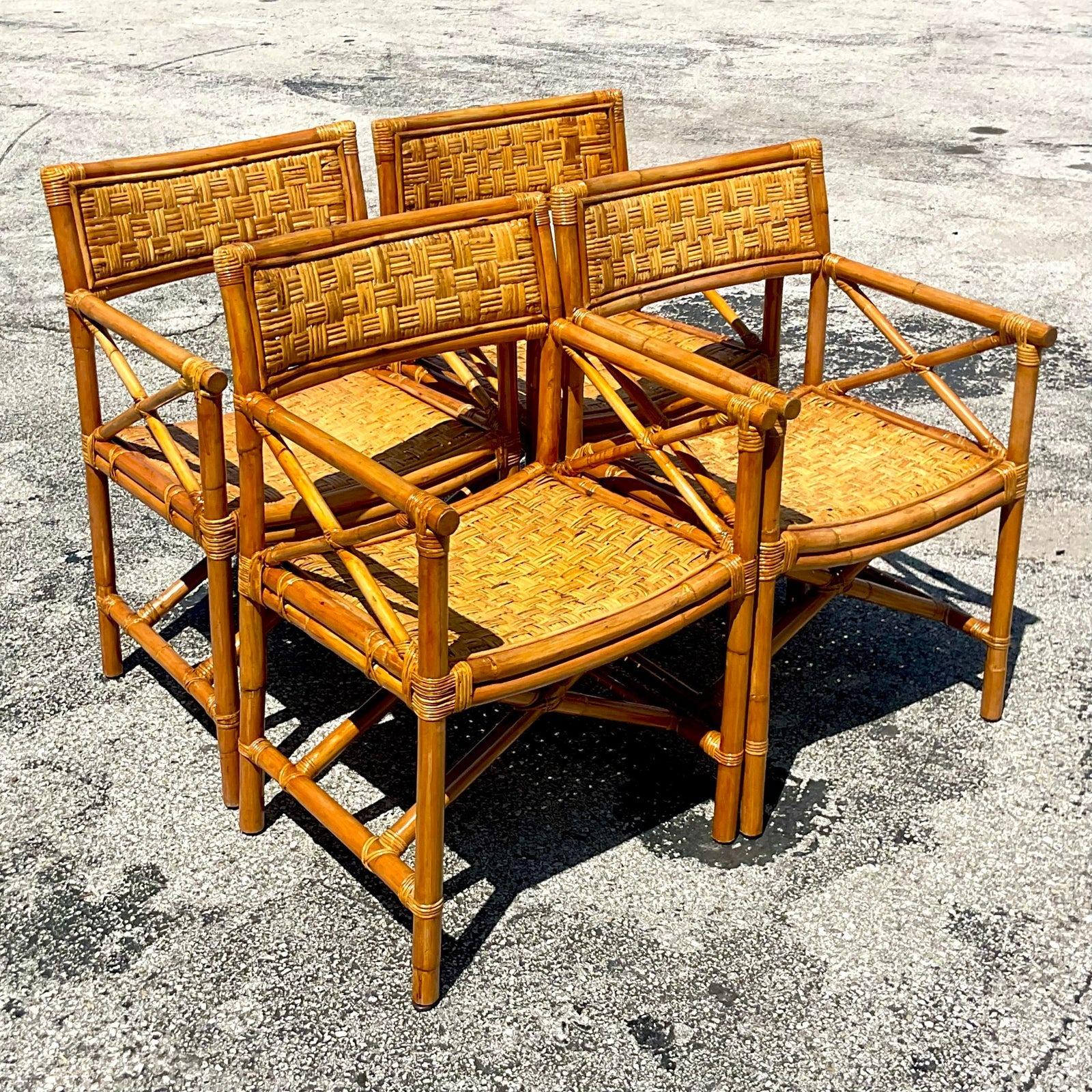 A fabulous set of four vintage Coastal dining chairs. A chic Directors style chair in woven rattan. Acquired from a Palm Beach estate.