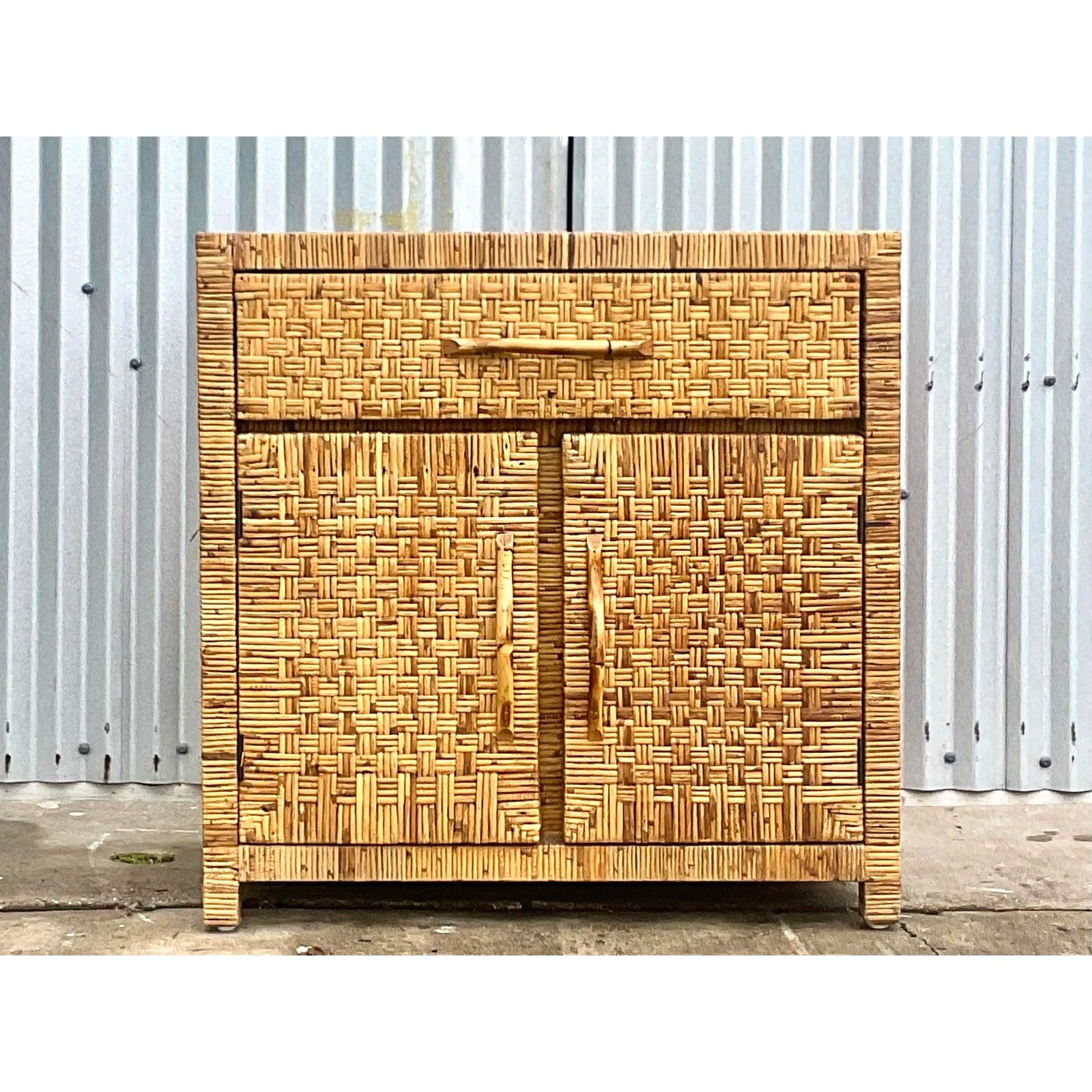 Fantastic vintage woven rattan sideboard. Gorgeous tortoise rattan in a chic and simple shape. Double doors and bamboo handles reveal lots of good storage. Perfect as a sideboard or a console cabinet. Or even an XL nightstand for those higher