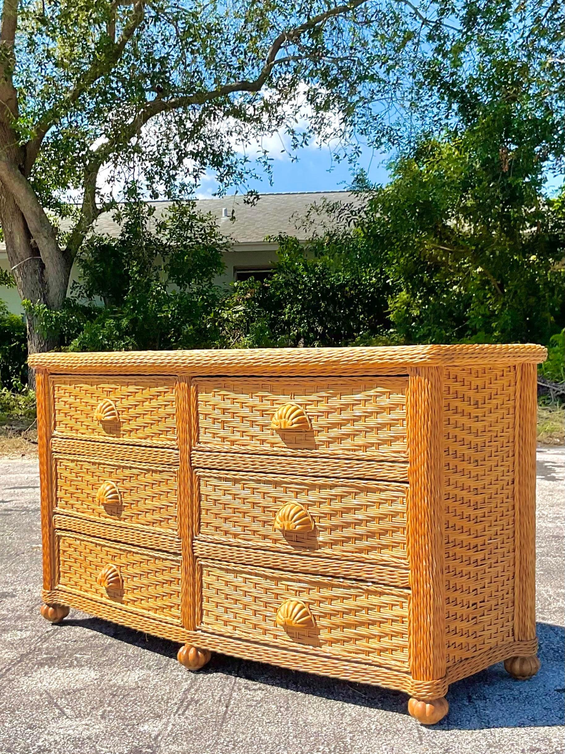 Fantastic vintage Coastal standard dresser. Beautiful woven rattan frame with hand carved shell drawer pulls. Matching chest of drawers also available on my Chairish page. Acquired from a Palm Beach estate. 