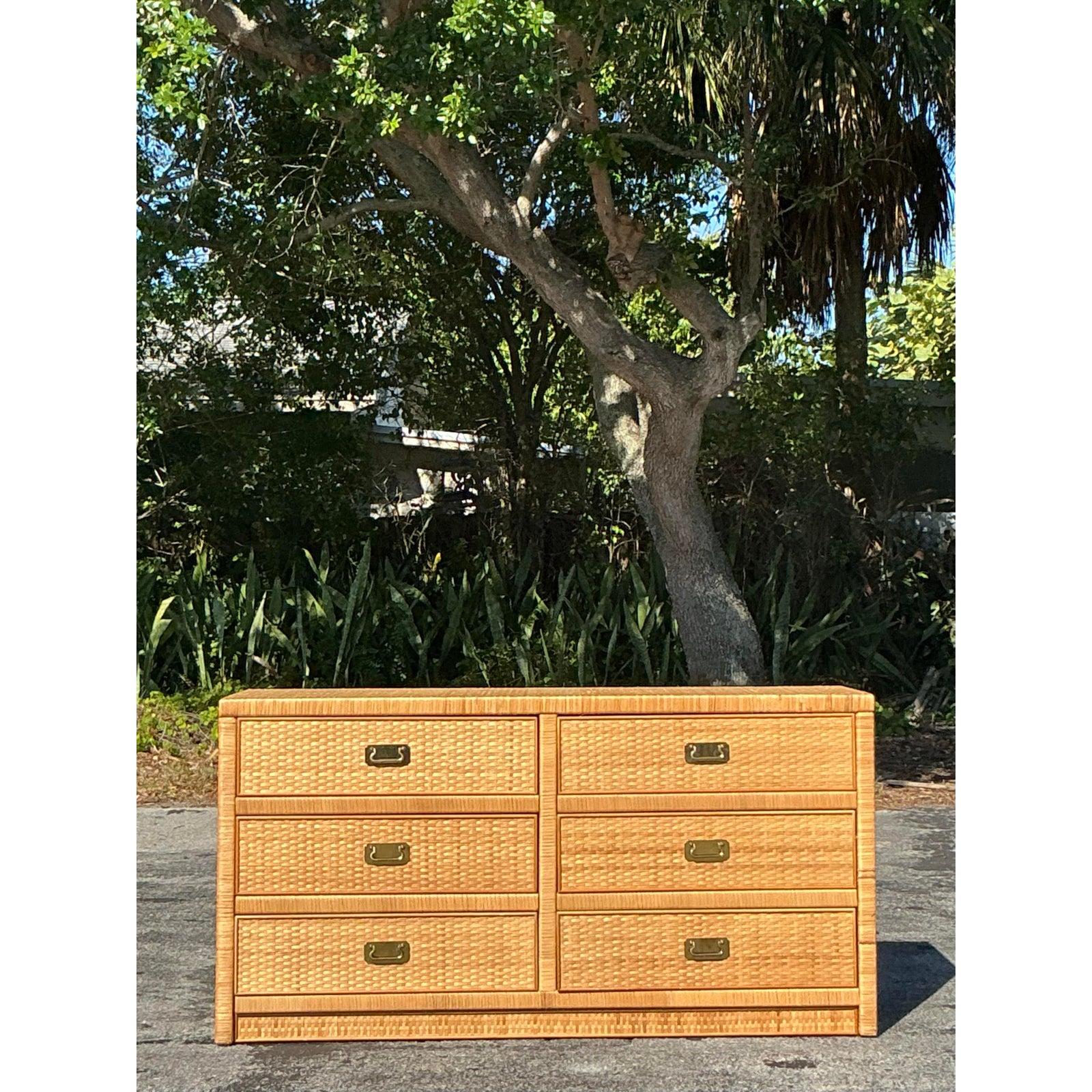 Bring a touch of tropical elegance into your home with this beautifully crafted vintage coastal woven rattan dresser. Featuring six spacious drawers, this piece showcases a meticulously woven rattan texture, framed by a sturdy wood structure for
