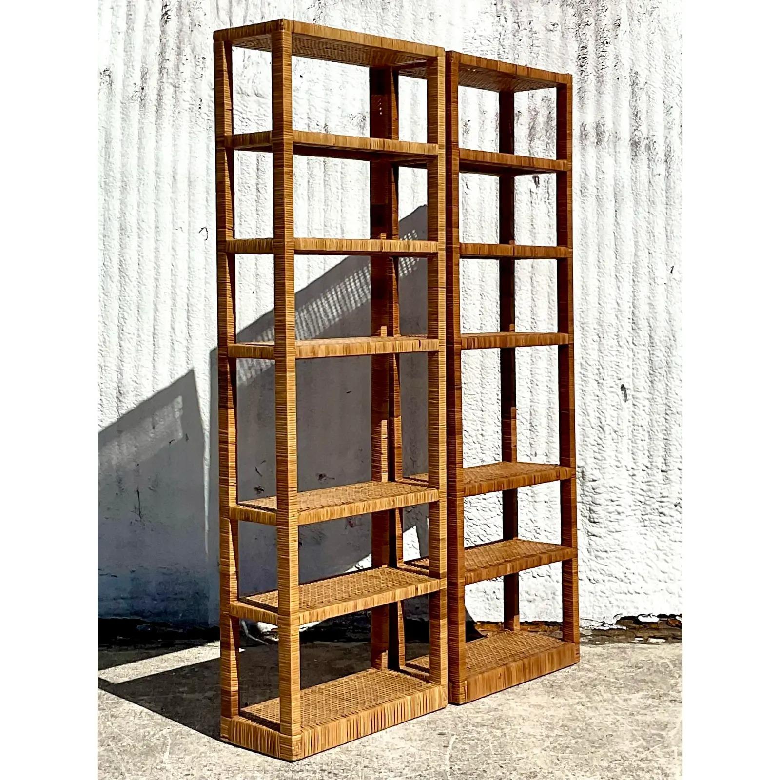 Fantastic pair of vintage woven rattan etagere. Gorgeous tall frame with a chic narrow design. Woven in the style of the iconic Bielecky Brothers. Acquired from a Palm Beach estate.