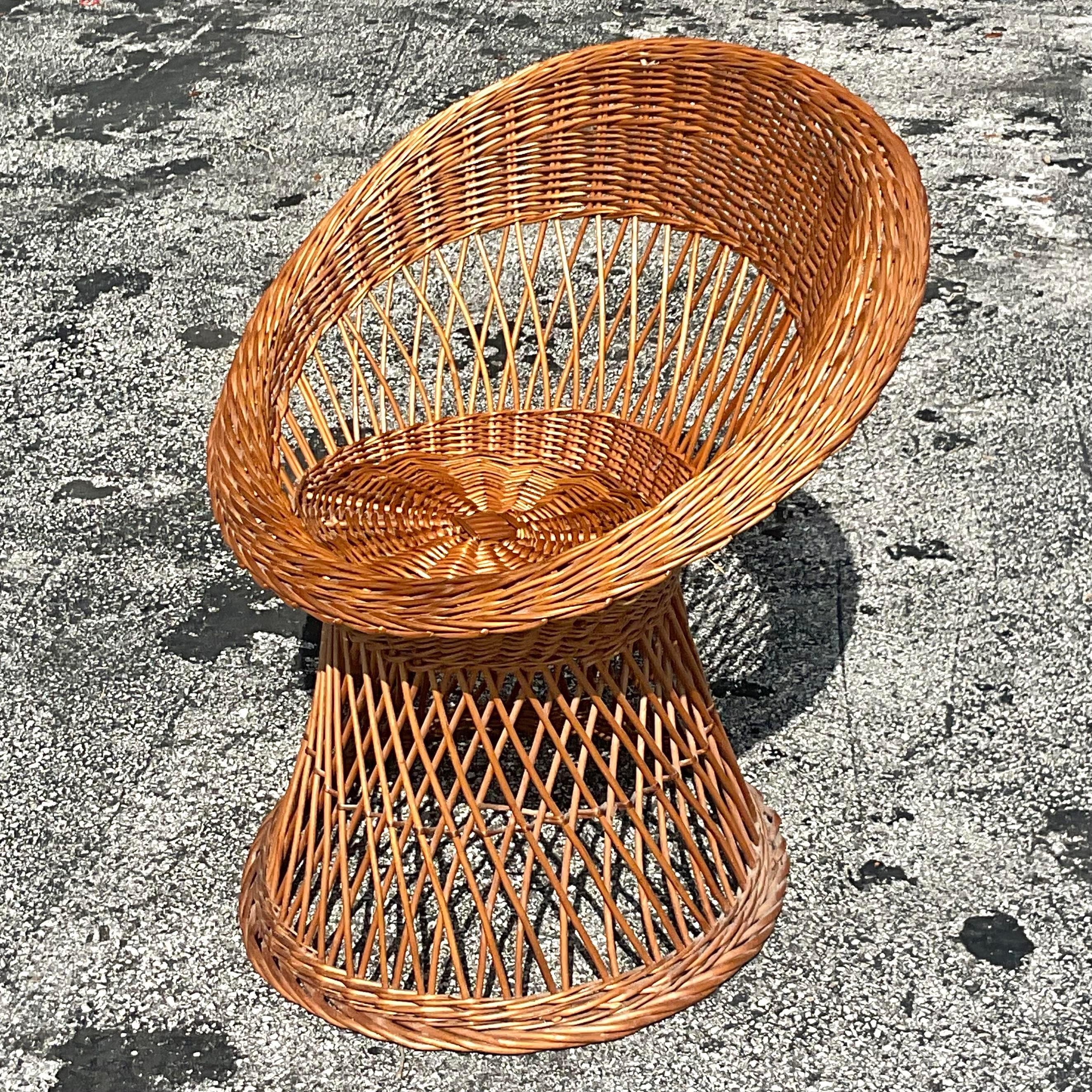 A fabulous vintage Coastal lounge chair. A chic woven rattan in a clean and modern design. Perfect to add a little coastal flash to any space. Acquired from a Palm Beach estate.