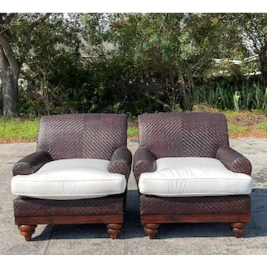 This stunning pair of vintage coastal woven rattan lounge chairs exudes timeless sophistication and coastal charm. With their intricately woven rattan craftsmanship, these chairs bring a touch of natural elegance to any interior. The plush white