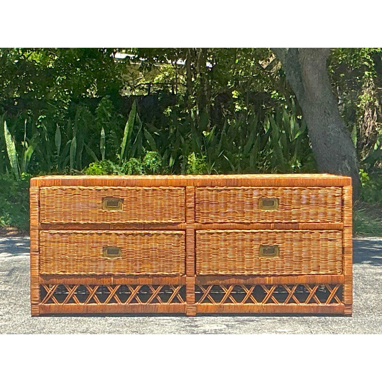 Embrace the relaxed elegance of coastal living with this captivating Vintage Woven Rattan Low Dresser, a versatile piece that exudes natural warmth and artisanal charm. This beautifully crafted dresser features an intricate woven rattan exterior,