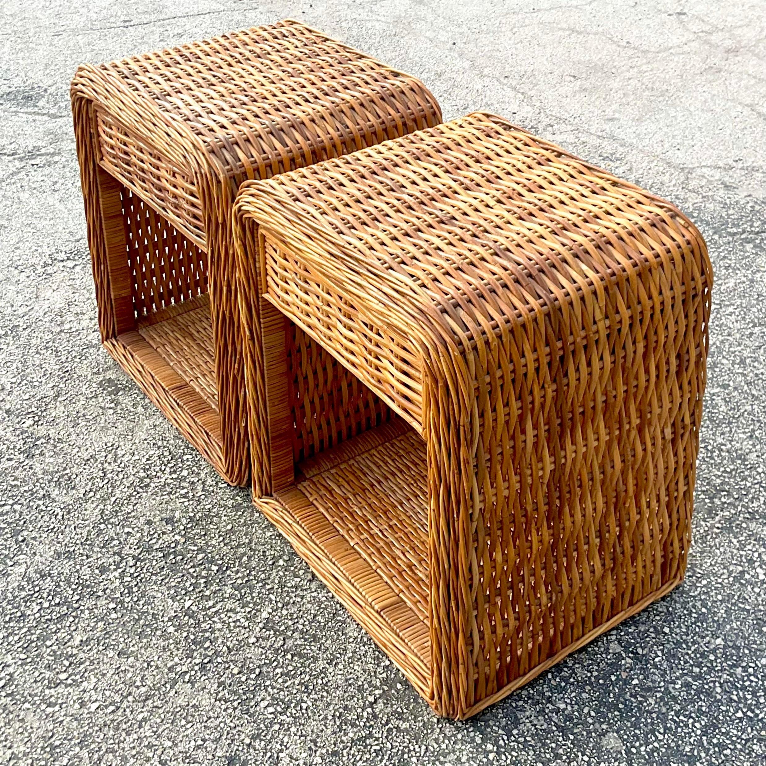 A fantastic pair of vintage Coastal nightstands. A beautiful woven rattan in a chic waterfall shape. Acquired from a Palm Beach estate.
