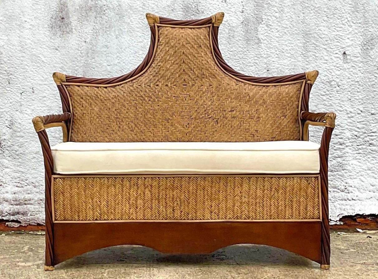 A fabulous vintage woven rattan bench. A chic pagoda style back with inset woven rattan panels. Wrapped rattan joints. Acquired from a Palm Beach estate.