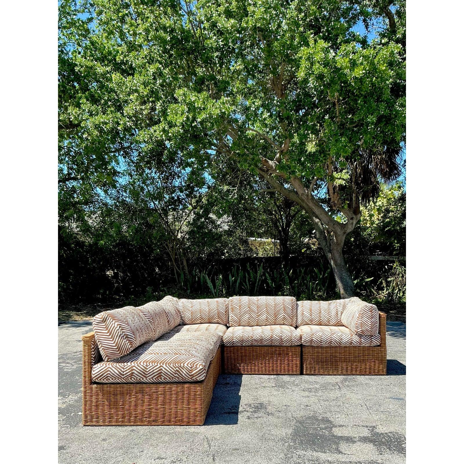 Elevate your interior with this stunning vintage coastal sectional sofa, crafted from natural woven rattan and adorned with Quadrille’s signature “Zig Zag” fabric. This modular piece features an effortlessly chic design, blending organic texture