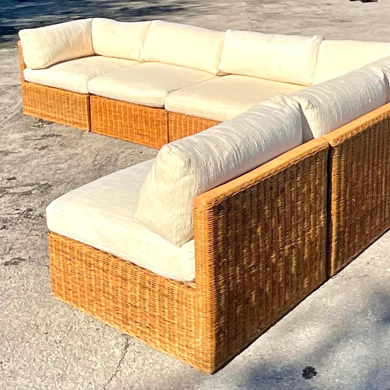 Incredible vintage Coastal sectional sofa. Beautiful woven rattan frame with slubbed cotton in a beautiful ivory. Move around the sections to suit your room. Acquired from a Palm Beach estate.

Each square section is 33 inches. So the return two