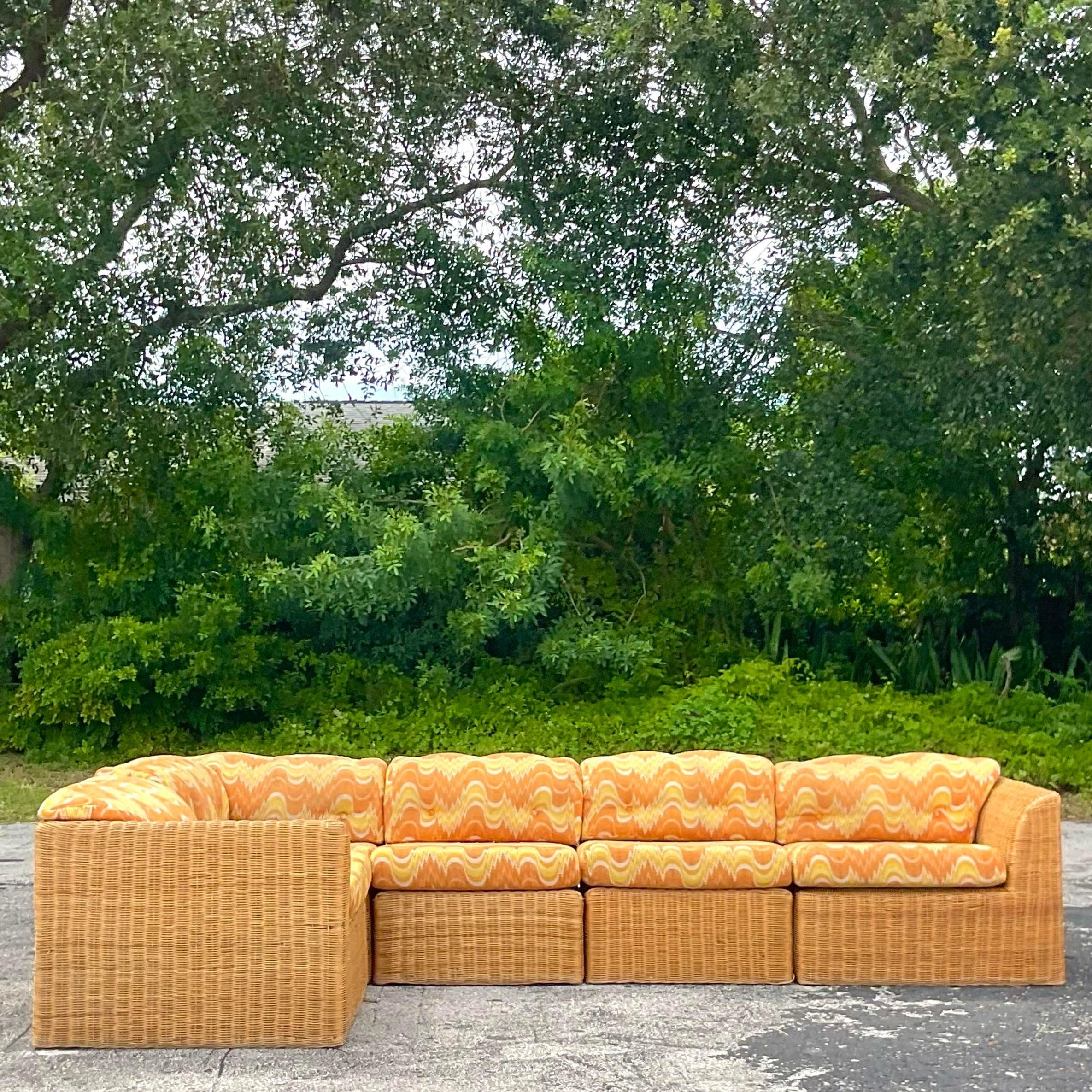 A fabulous vintage Coastal sectional sofa. A chic woven rattan frame with the most amazing vintage flame stitch upholstery. A real statement piece. Acquired from a Palm Beach estate.

Long side 121
Short side return 67
Corner piece 33x33x30h
Slipper