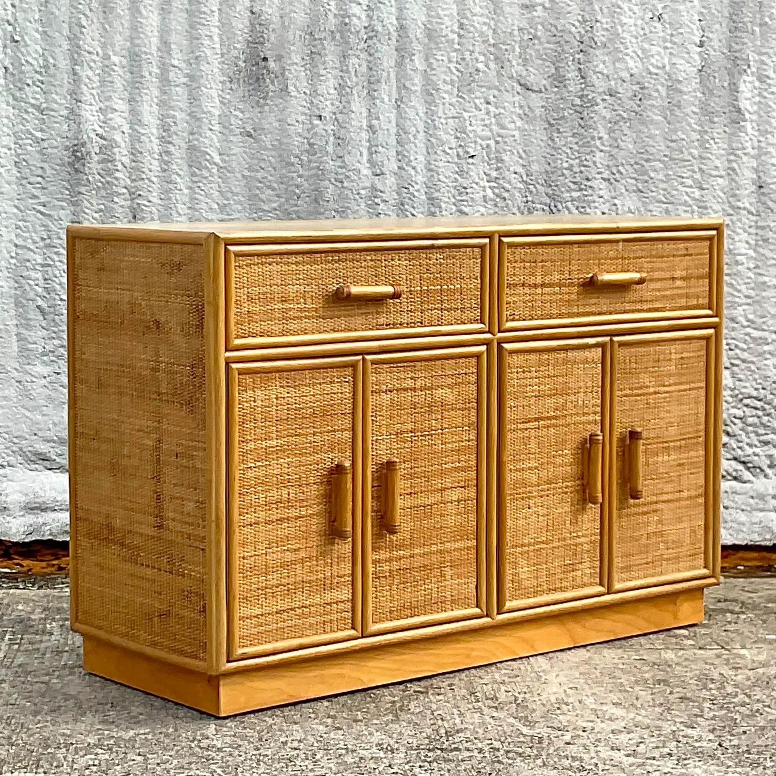 A fabulous vintage Coastal sideboard. A beautiful woven rattan case with lists of great storage below. Laminate faux wood top in great shape. Perfect for a high traffic area or glam it up with a mirrored top or a piece of stone. You decide! Lots of