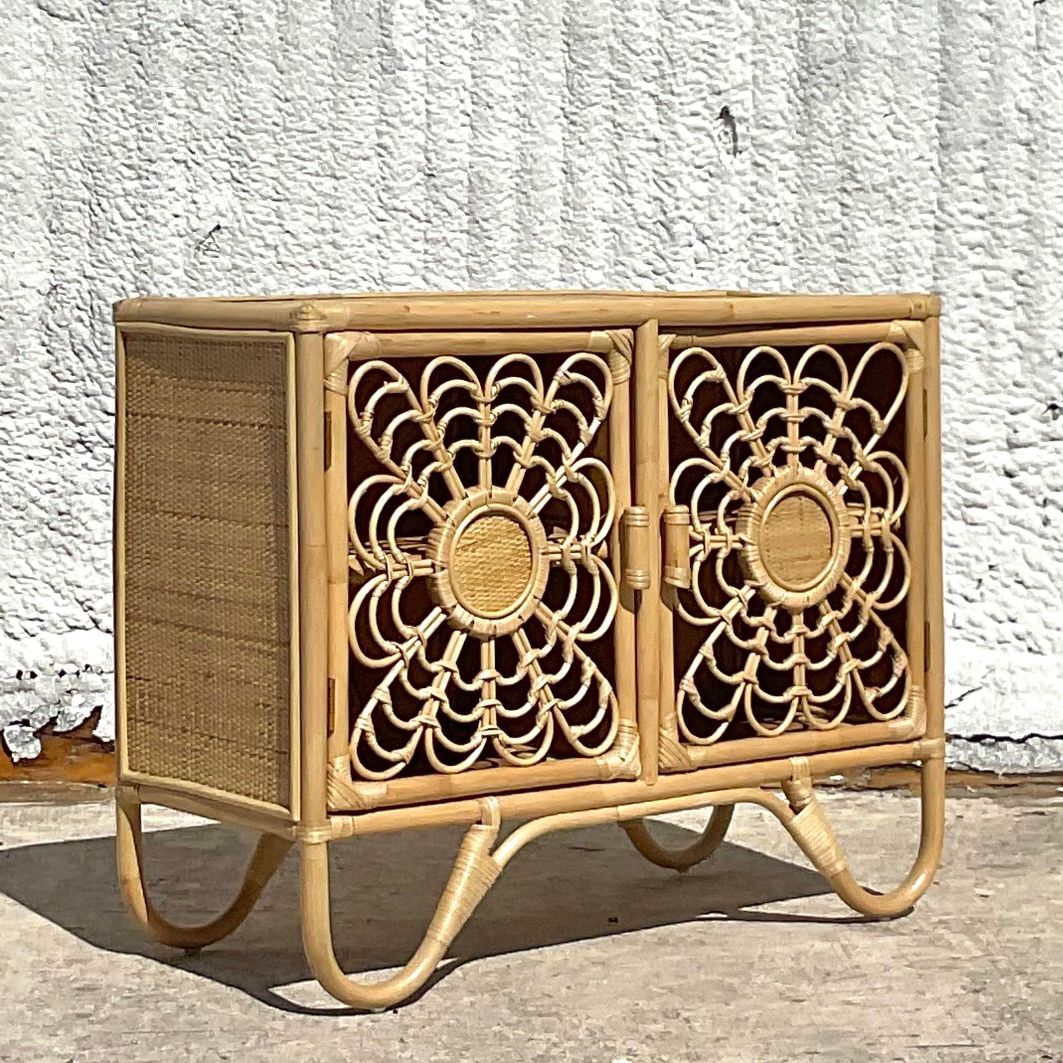 A fabulous vintage coastal sideboard. Beautiful floral rattan design with inset woven rattan panels. Lots of great storage inside. Acquired from a Palm Beach estate