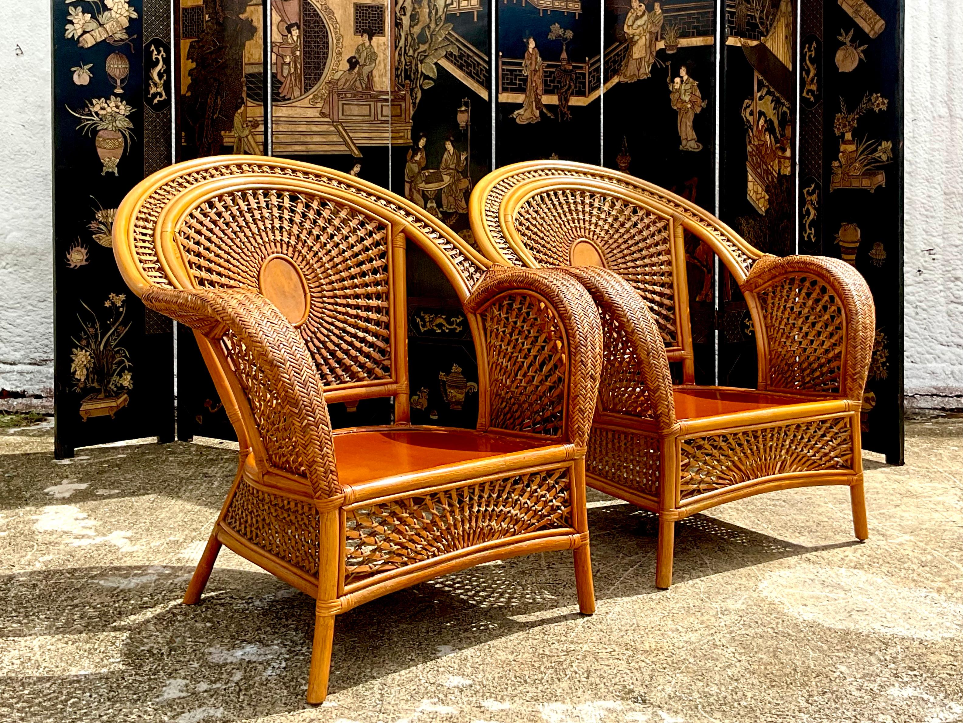 Fantastic pair of vintage Coastal lounge chairs. Gorgeous woven rattan in a chic spider web design. Acquired from a Palm Beach estate.