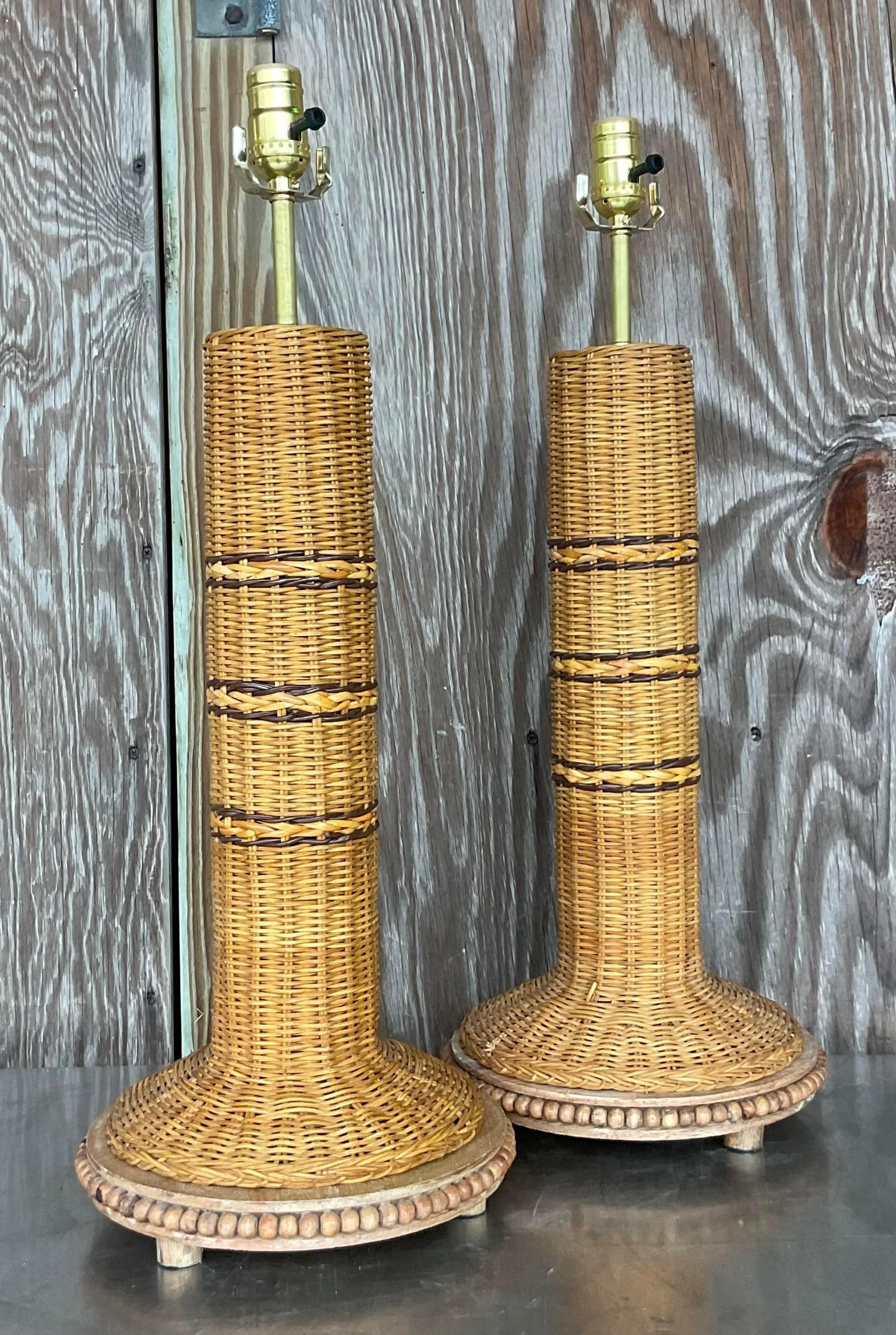 A fabulous pair of vintage Coastal table lamps. Chic woven rattan in natural with stripes of chocolate brown. Fully restored with all new wiring and hardware. Acquired from a Palm Beach estate.