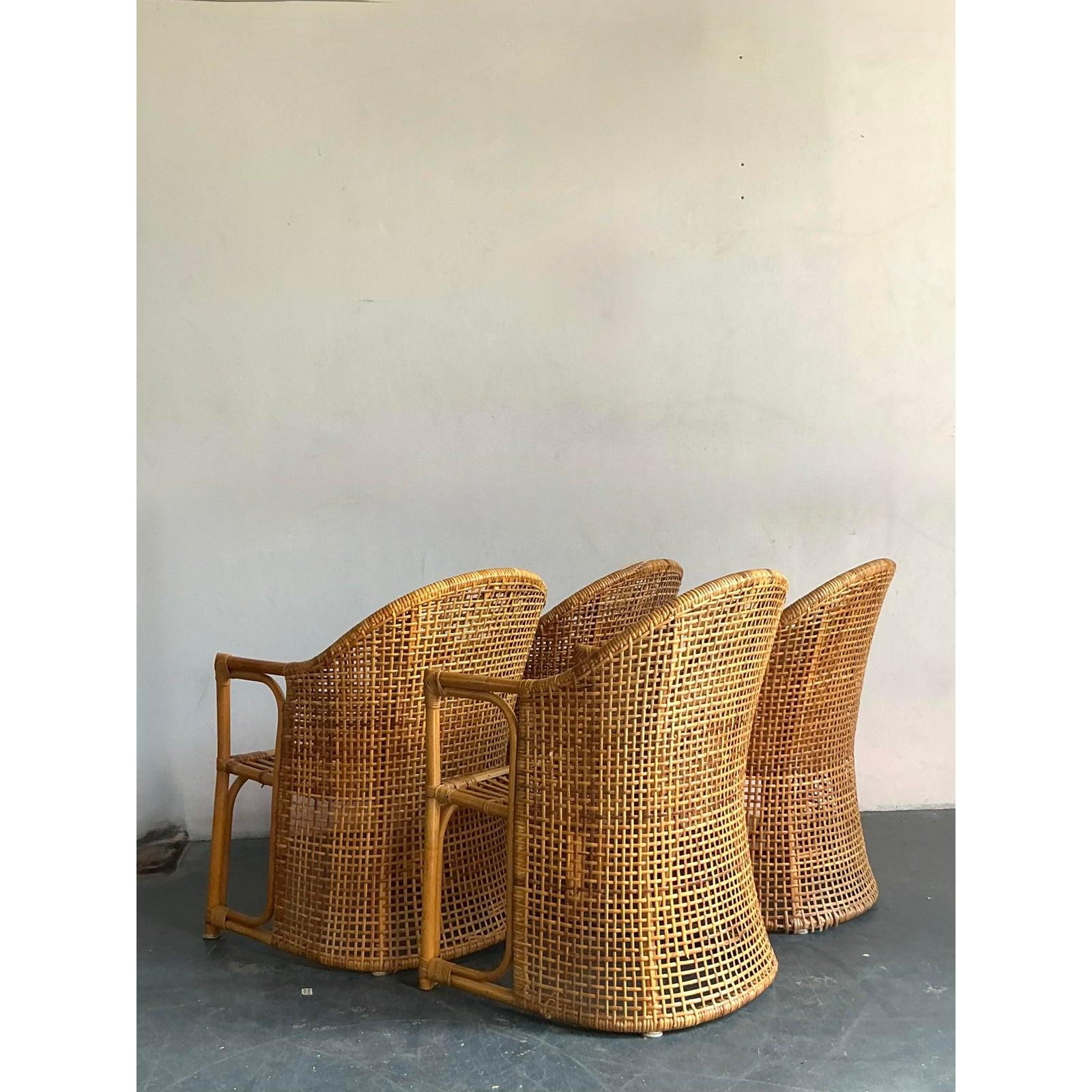 Embrace the relaxed elegance of coastal living with this exquisite set of four vintage woven rattan tub chairs. Crafted with meticulous artistry, these chairs embody a timeless charm, perfect for adding a touch of natural sophistication to any