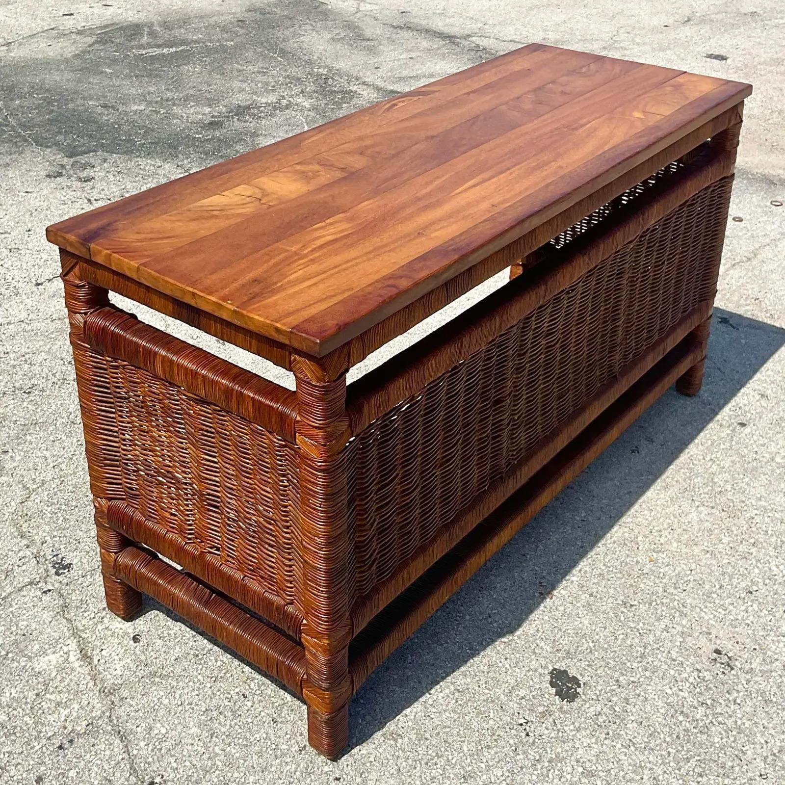 Fantastic vintage Coastal desk. A beautiful woven rattan with a wood plank top. Fabulous wood grain detail to the top. Acquired from a Palm Beach estate.