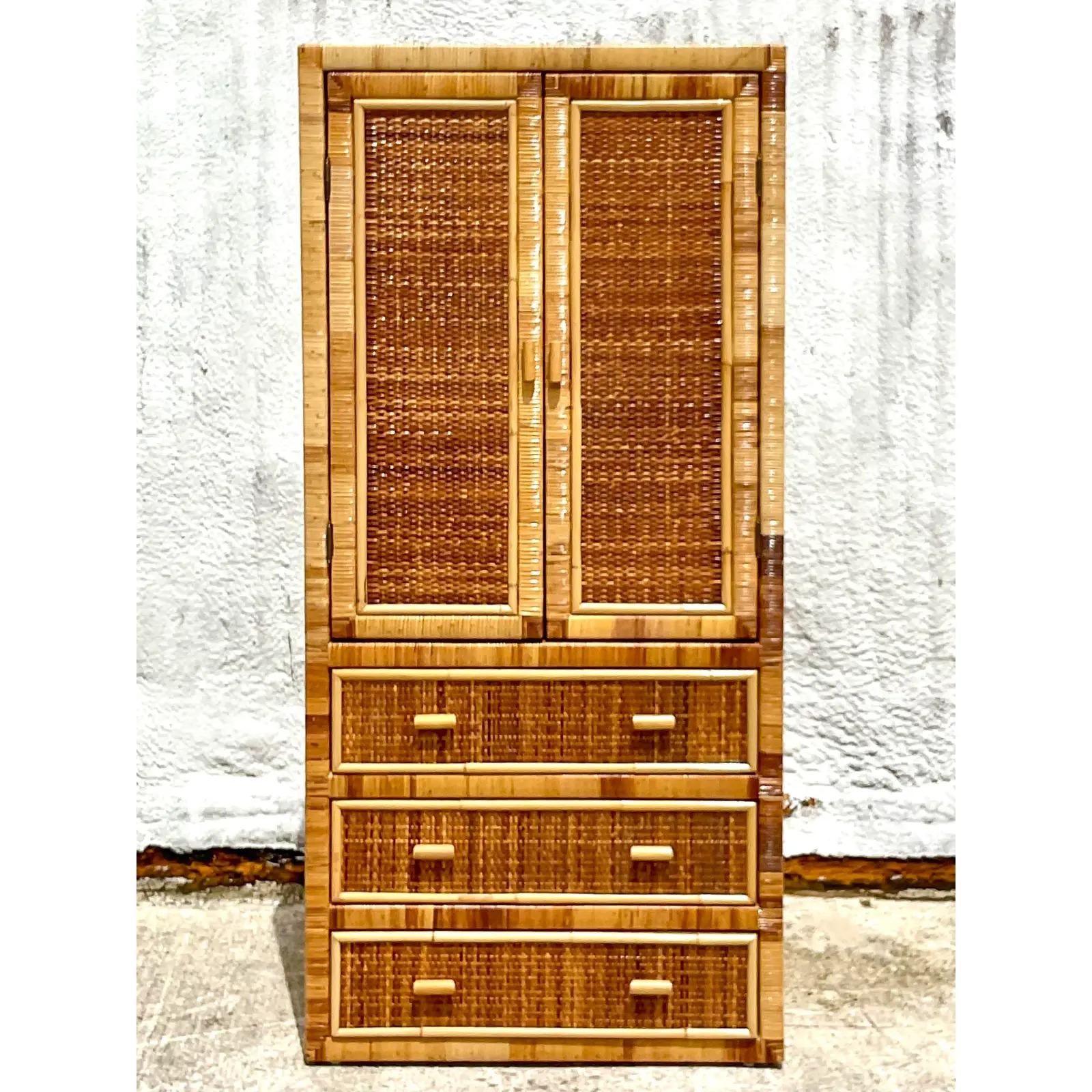 Fantastic vintage Coastal armoire. Beautiful wrapped rattan with inset woven rattan panels. Lots of great storage. Acquired from a Palm Beach estate.