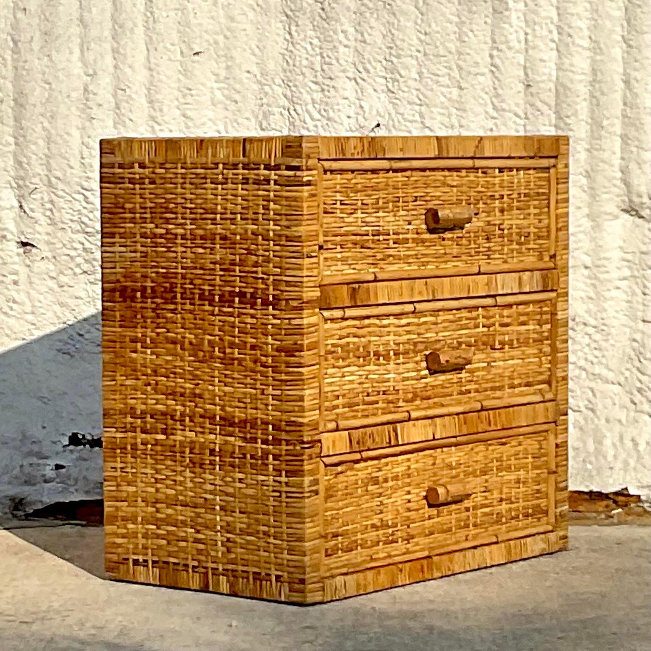 A fantastic vintage costal chest of drawers. Beautiful wrapped rattan with beautiful woven rattan panels. Perfect as a chest, but also great as a nightstand. Acquired from a Palm Beach estate.