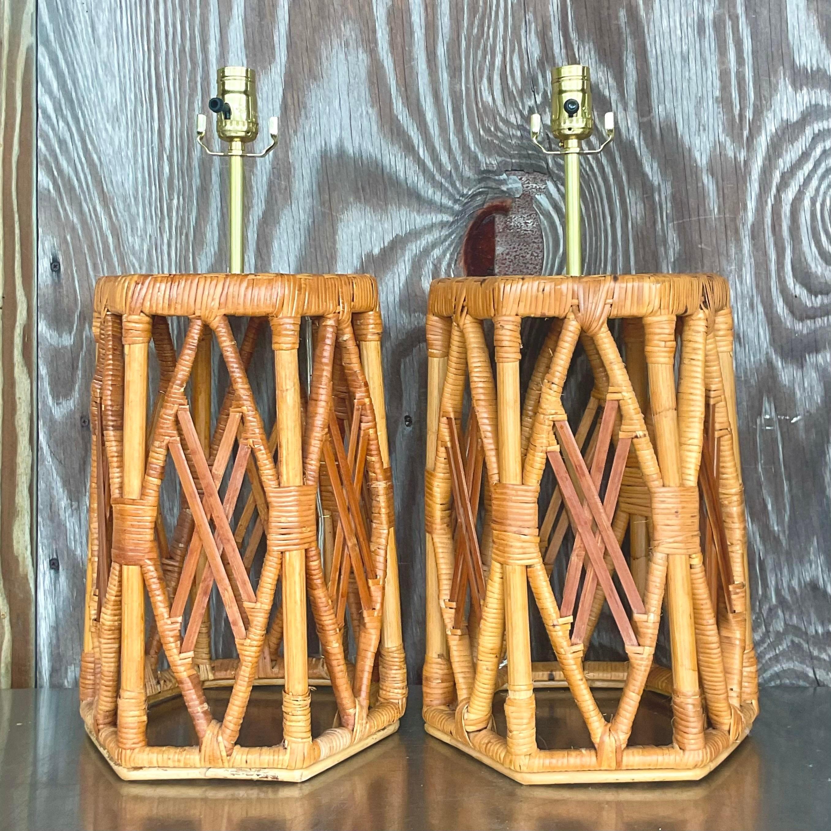 A fabulous pair of vintage Coastal table lamps. A chic wrapped rattan open frame with no interior hardware. Fully restored with all new wiring and hardware. Two sets available on my  page. Acquired from a Palm Beach estate.