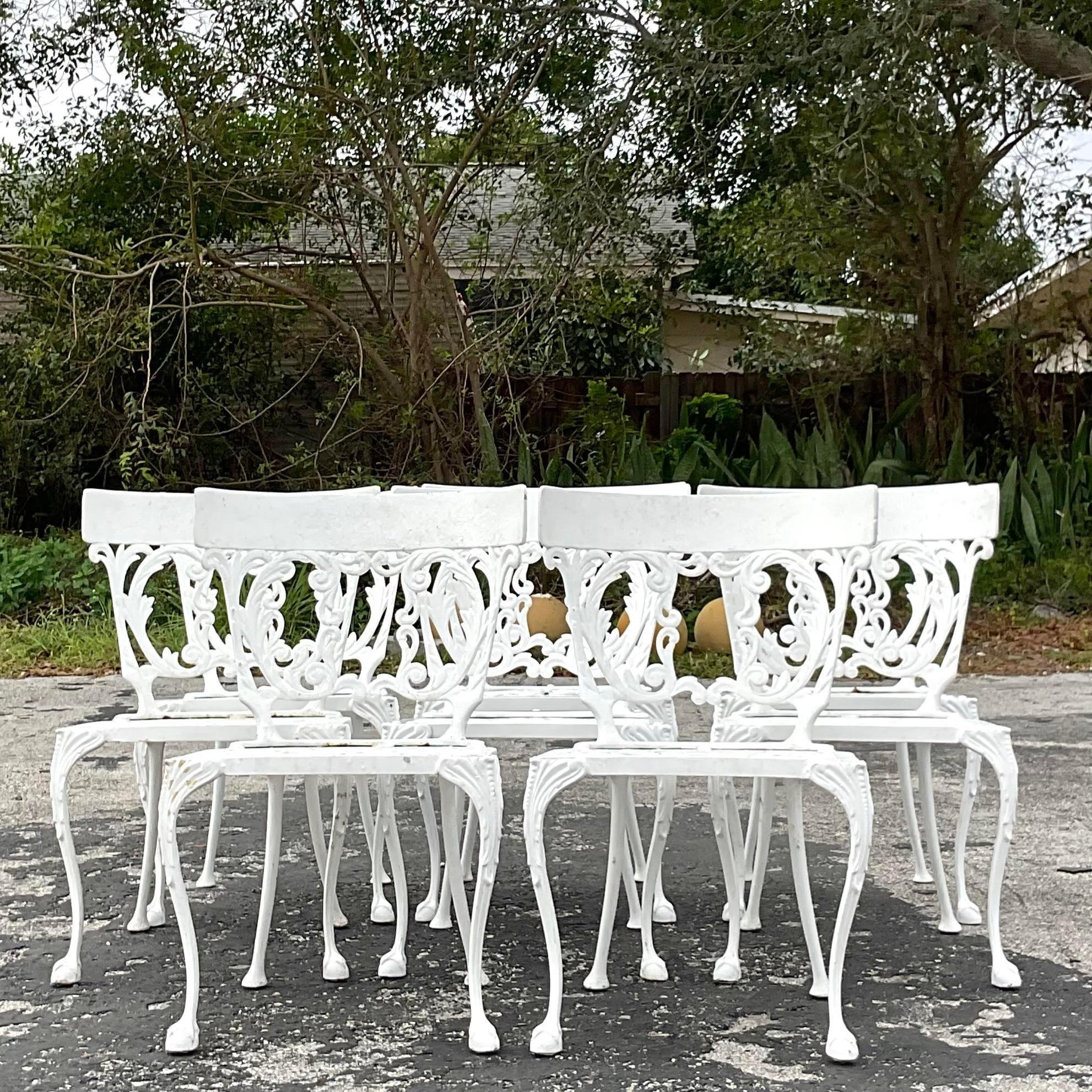 A fabulous set of 8 vintage Coastal outdoor dining chairs. A chic Klismos back with a garden design on a wrought iron flame. Freshly lacquered bright white. An addition set of the same chair with a slightly lower back also available on my page. Also