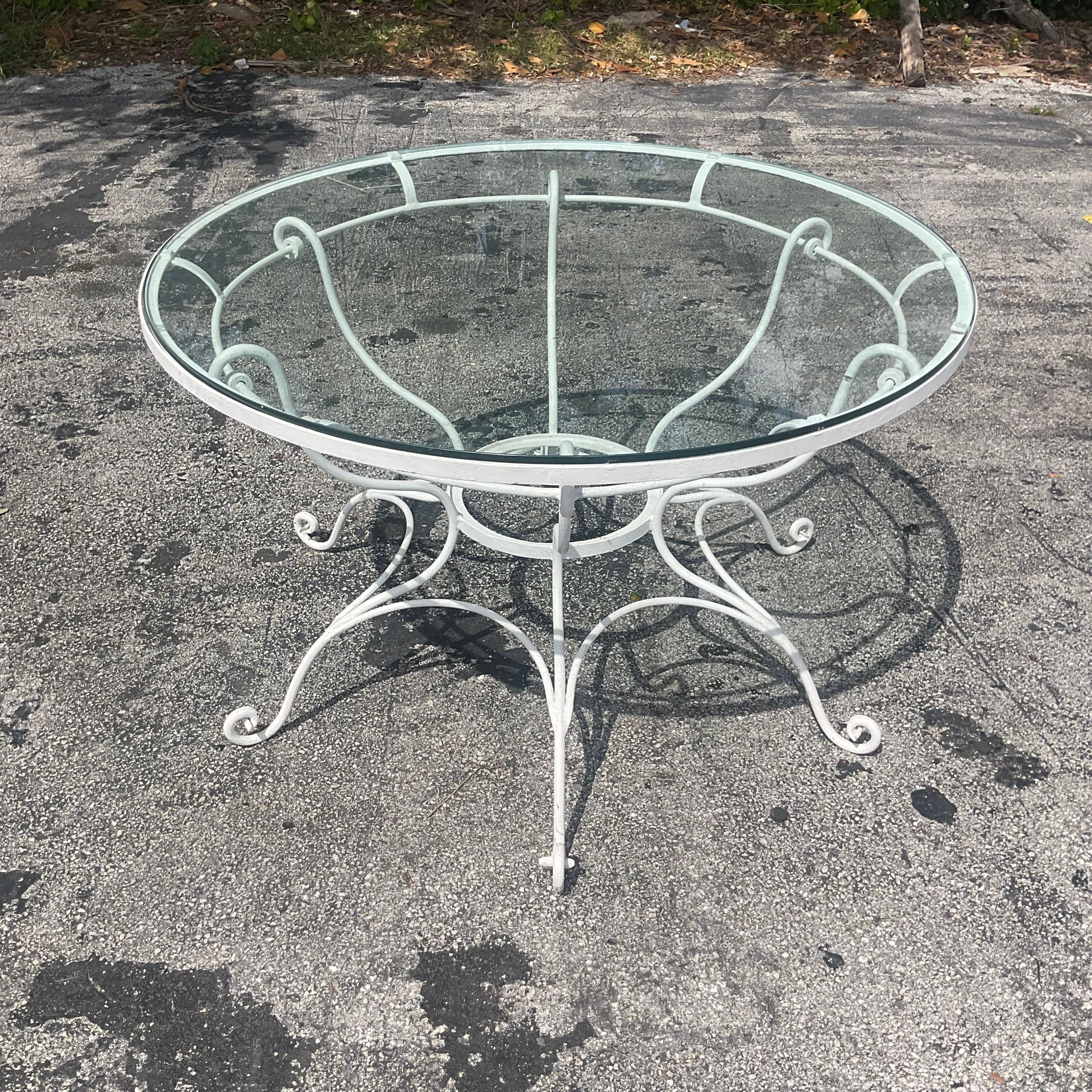 Elevate your dining experience with our Vintage Coastal Wrought Iron Scroll Dining Table, epitomizing the enduring charm of American craftsmanship and coastal elegance. Crafted with meticulous attention to detail, this table features intricate